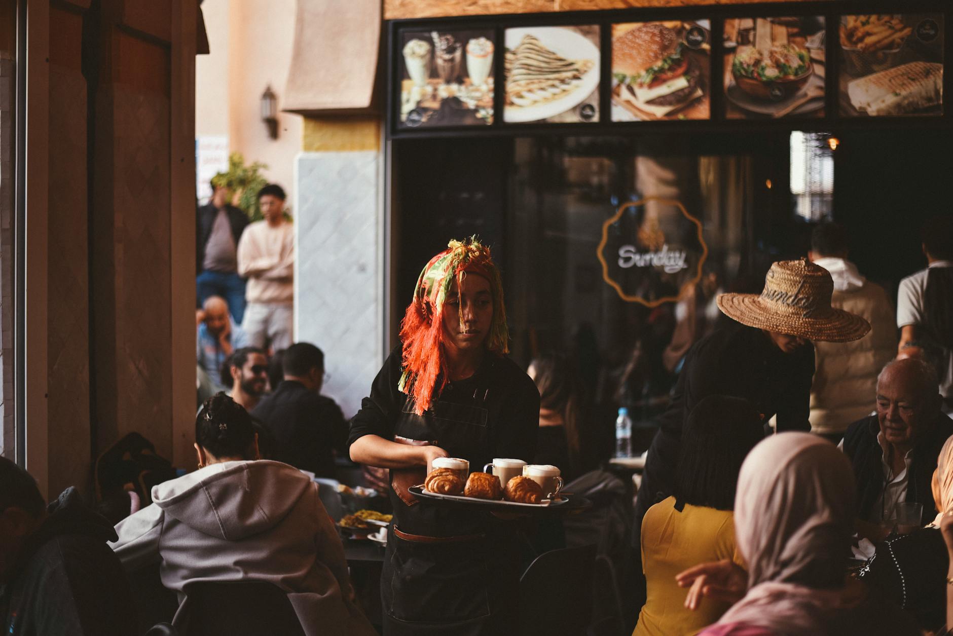Busy Moroccan cafe scene in Agadir with pastries