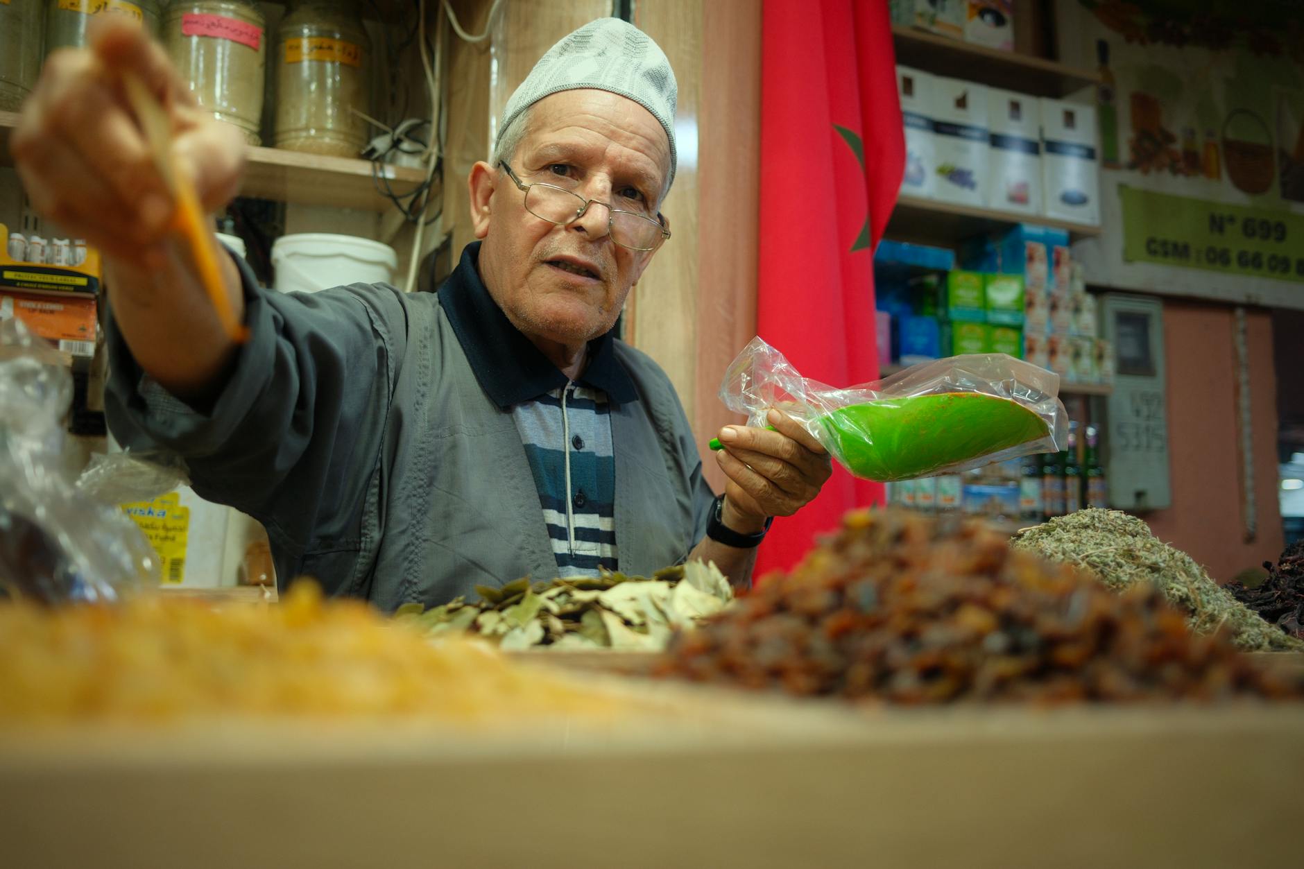 Traditional Moroccan spice market vendor with colorful spices