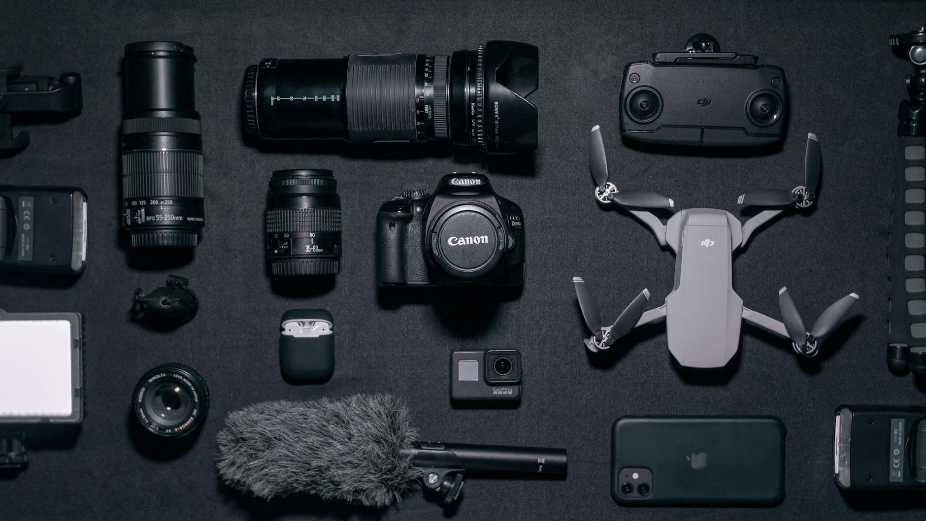 Photography gadgets and drone arranged on a dark surface