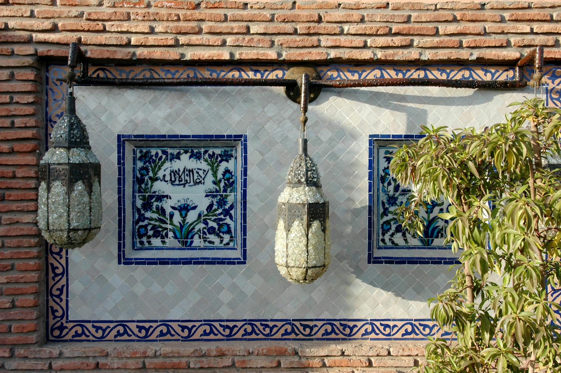 Decorative Moroccan wall with lanterns and tilework in Marrakech