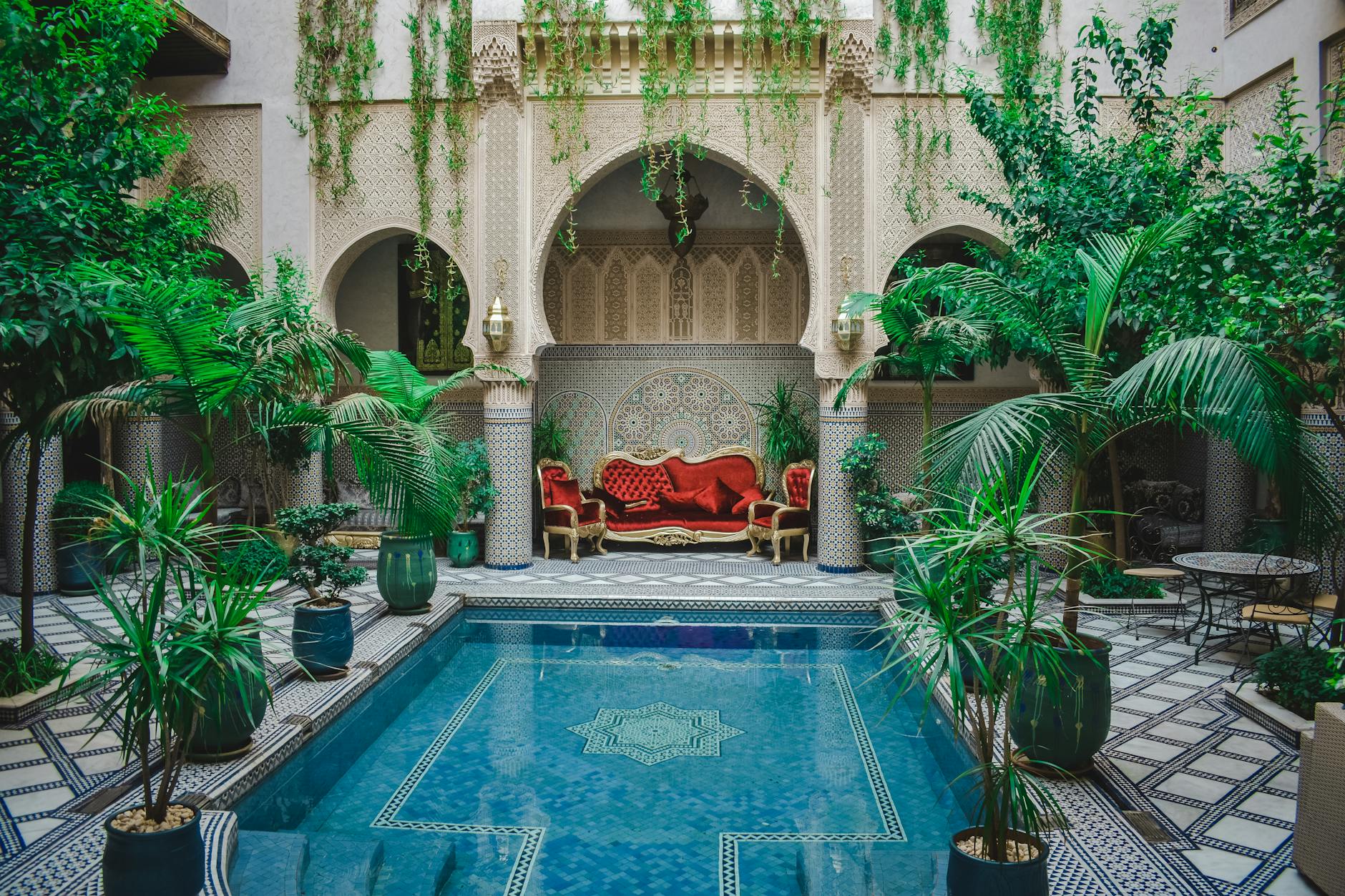Elegant Moroccan courtyard with greenery and a decorative pool