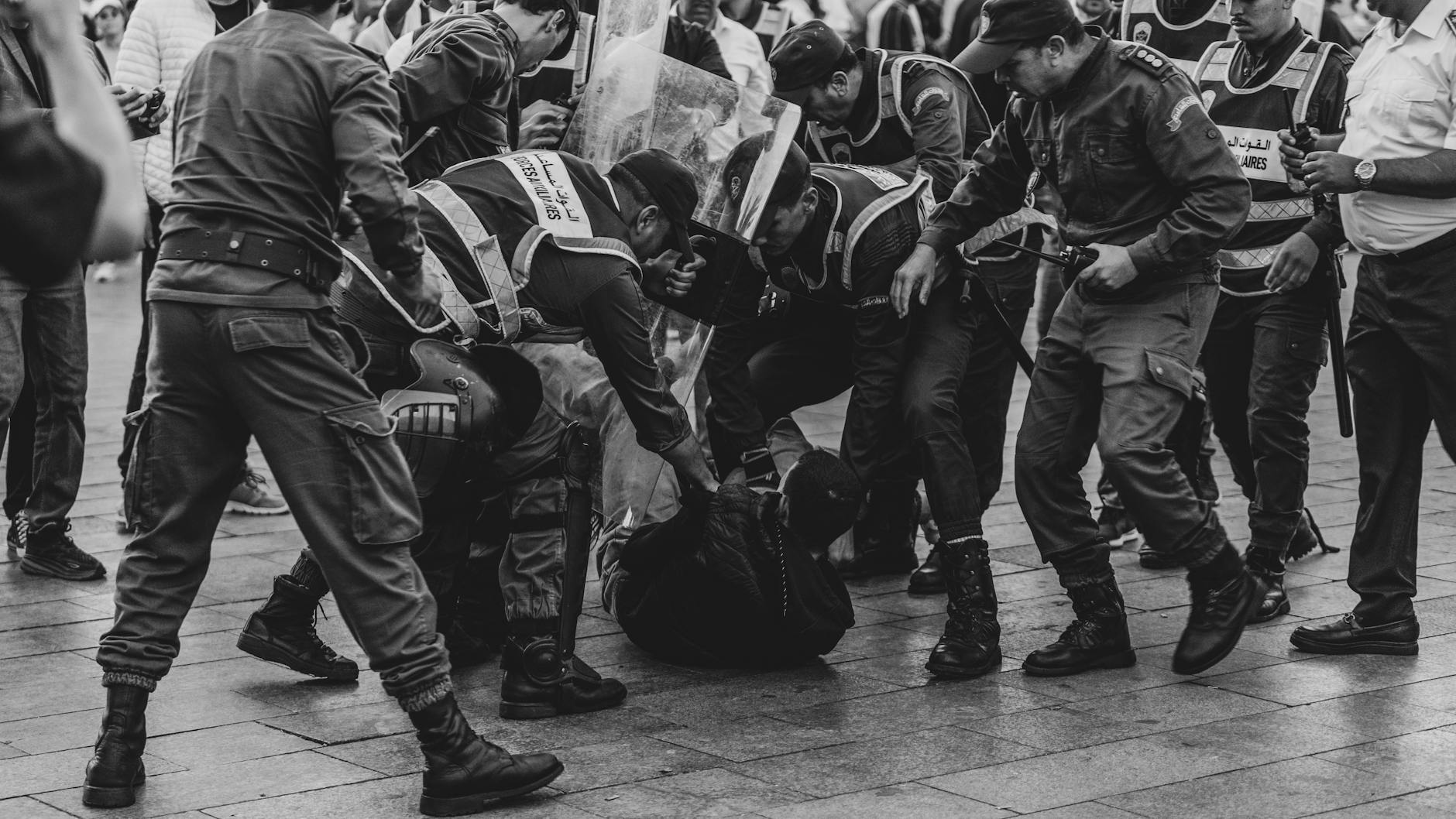 Police officers detaining a protester during a demonstration in Rabat, Morocco