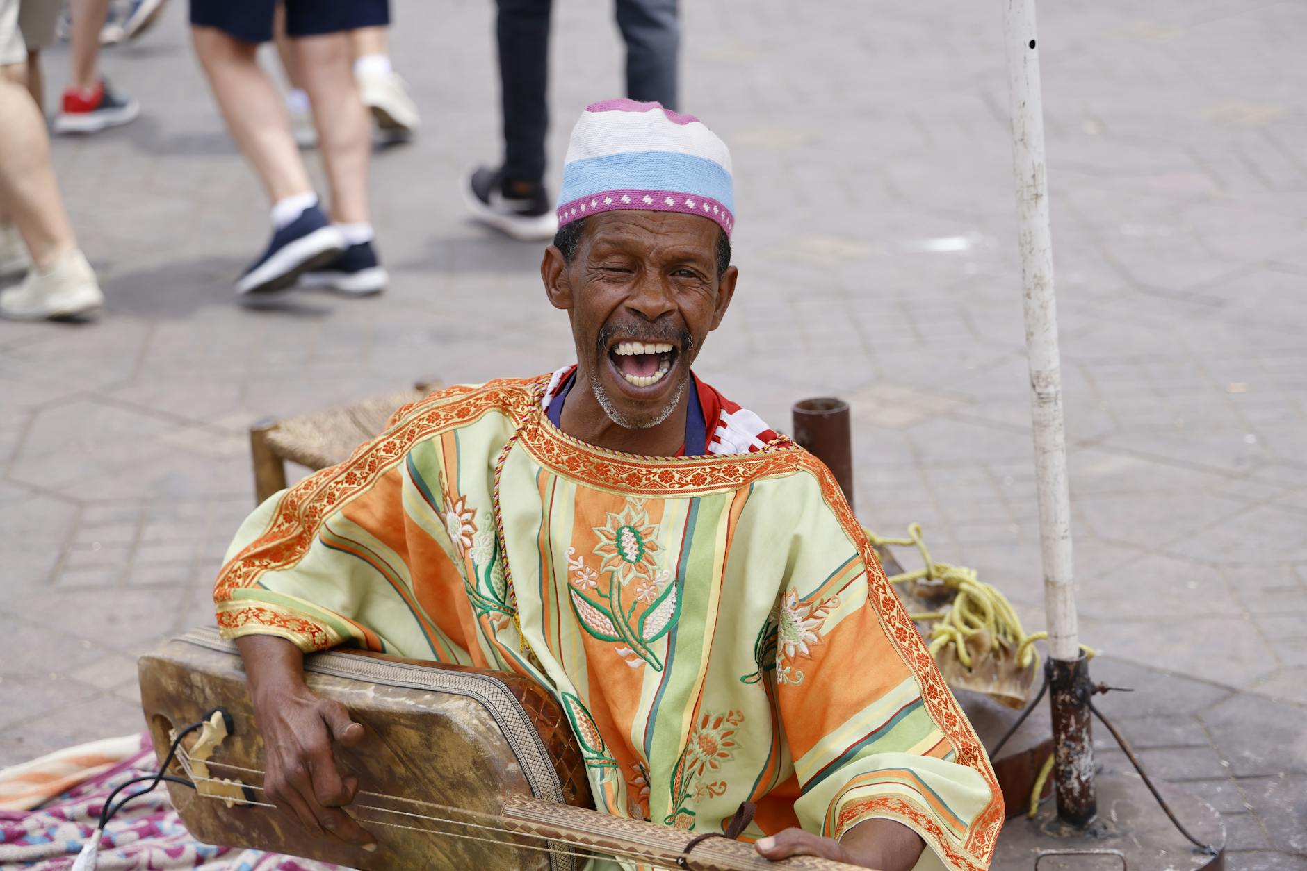 Gnawa musician singing and playing on a Moroccan street