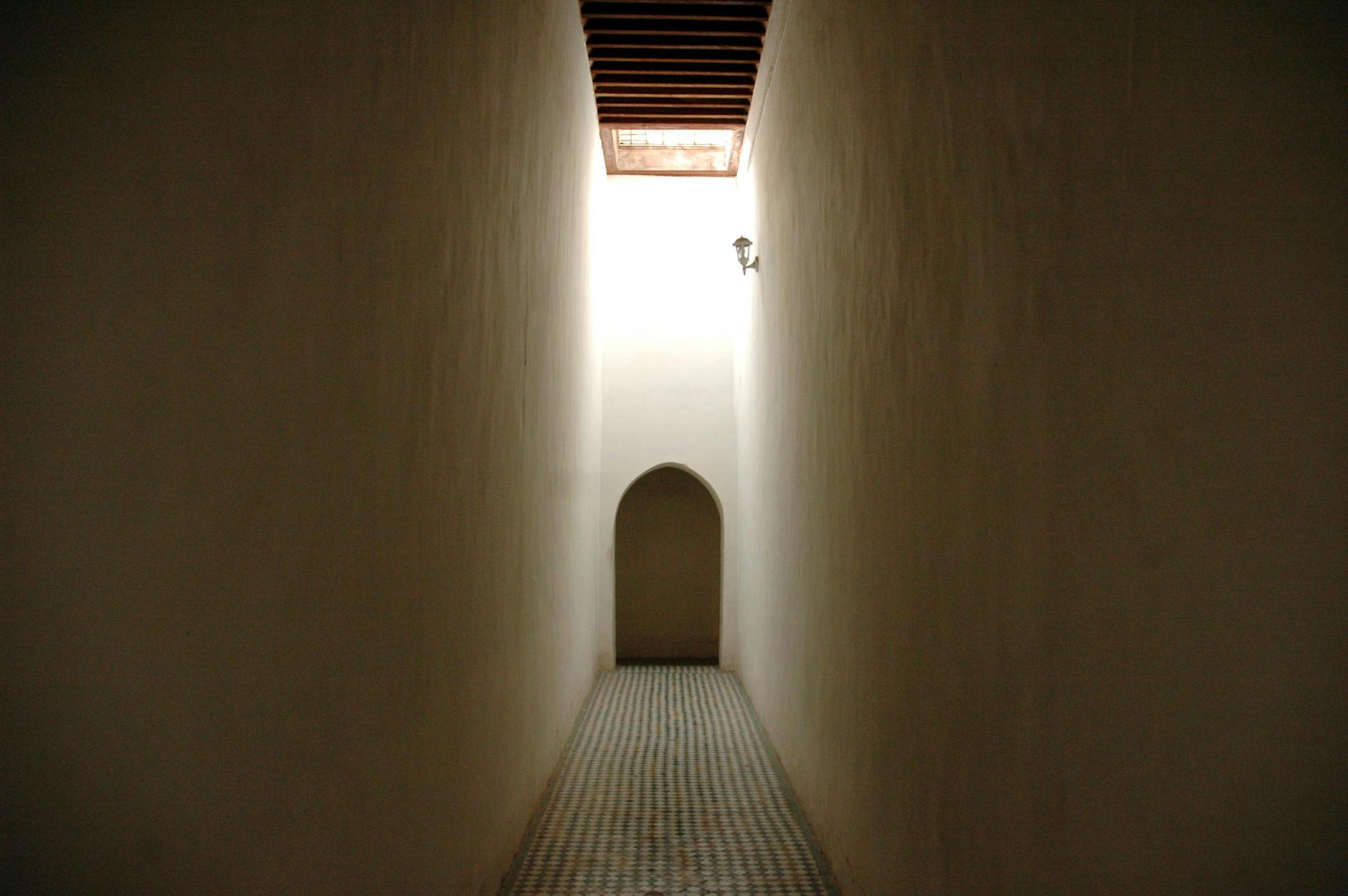 Softly lit narrow corridor with traditional Moroccan tiles in Marrakech