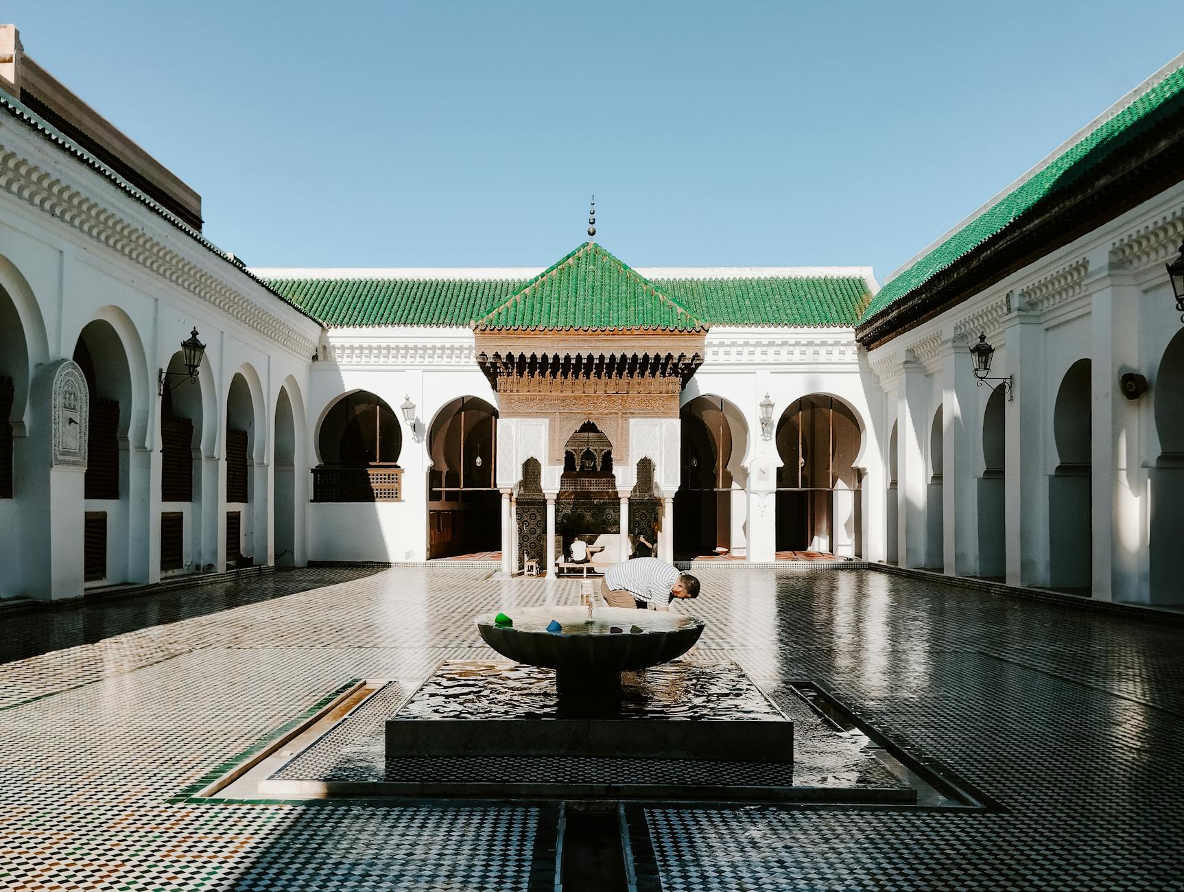 Historic mosque courtyard with ornate fountain in Fes, Morocco