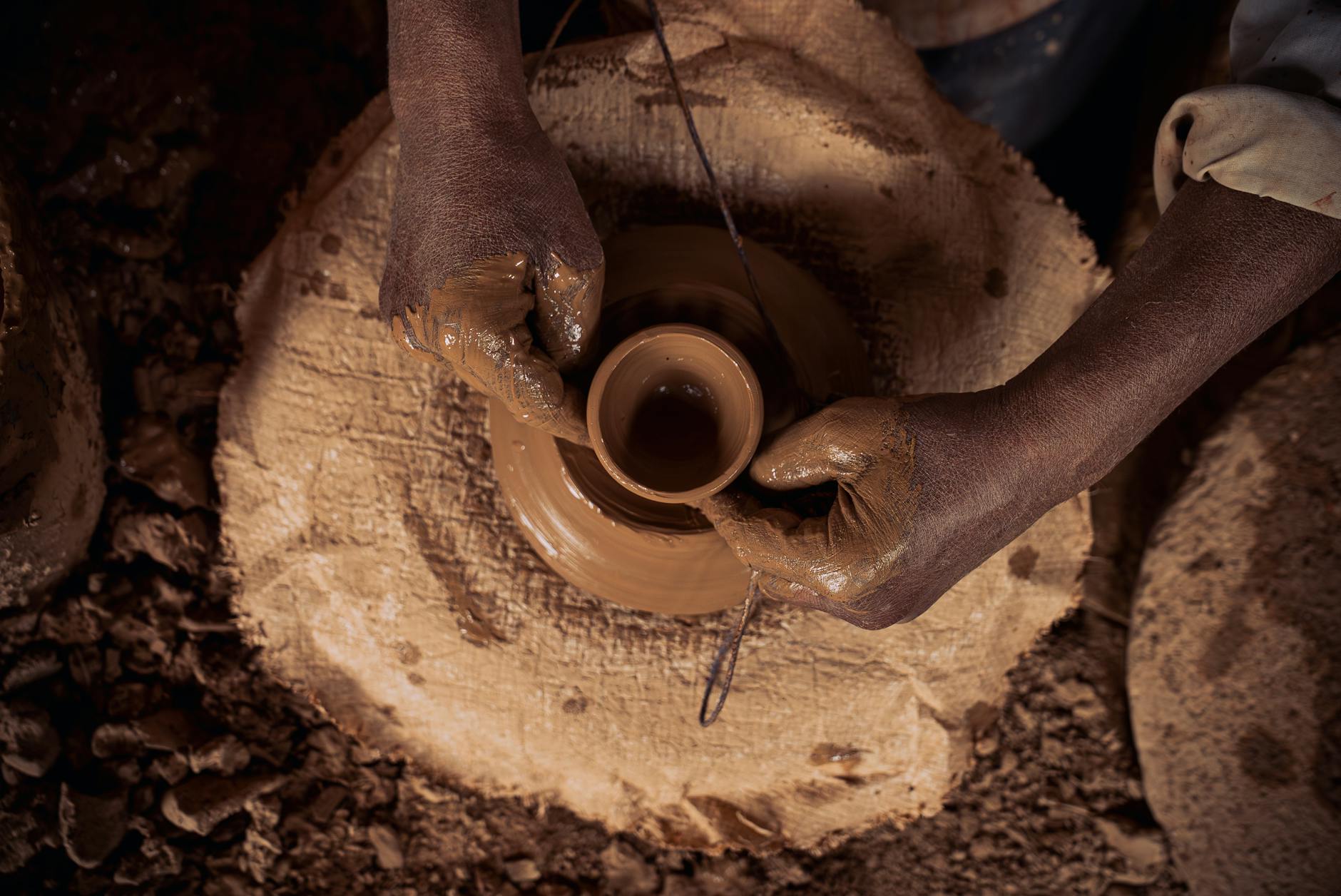 Artisan shaping clay on a potter's wheel in Marrakech