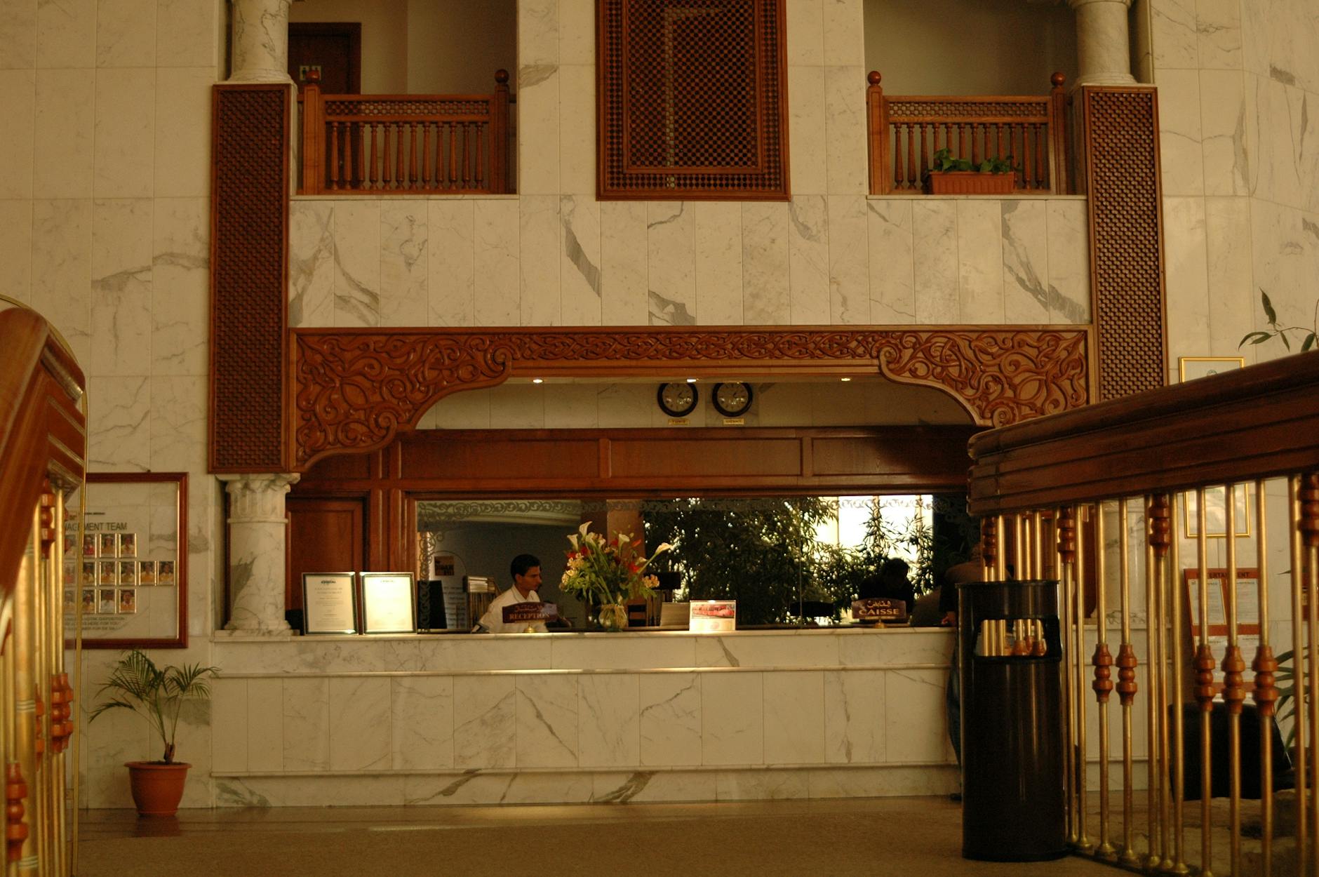 Elegant hotel reception area with polished wood and marble details