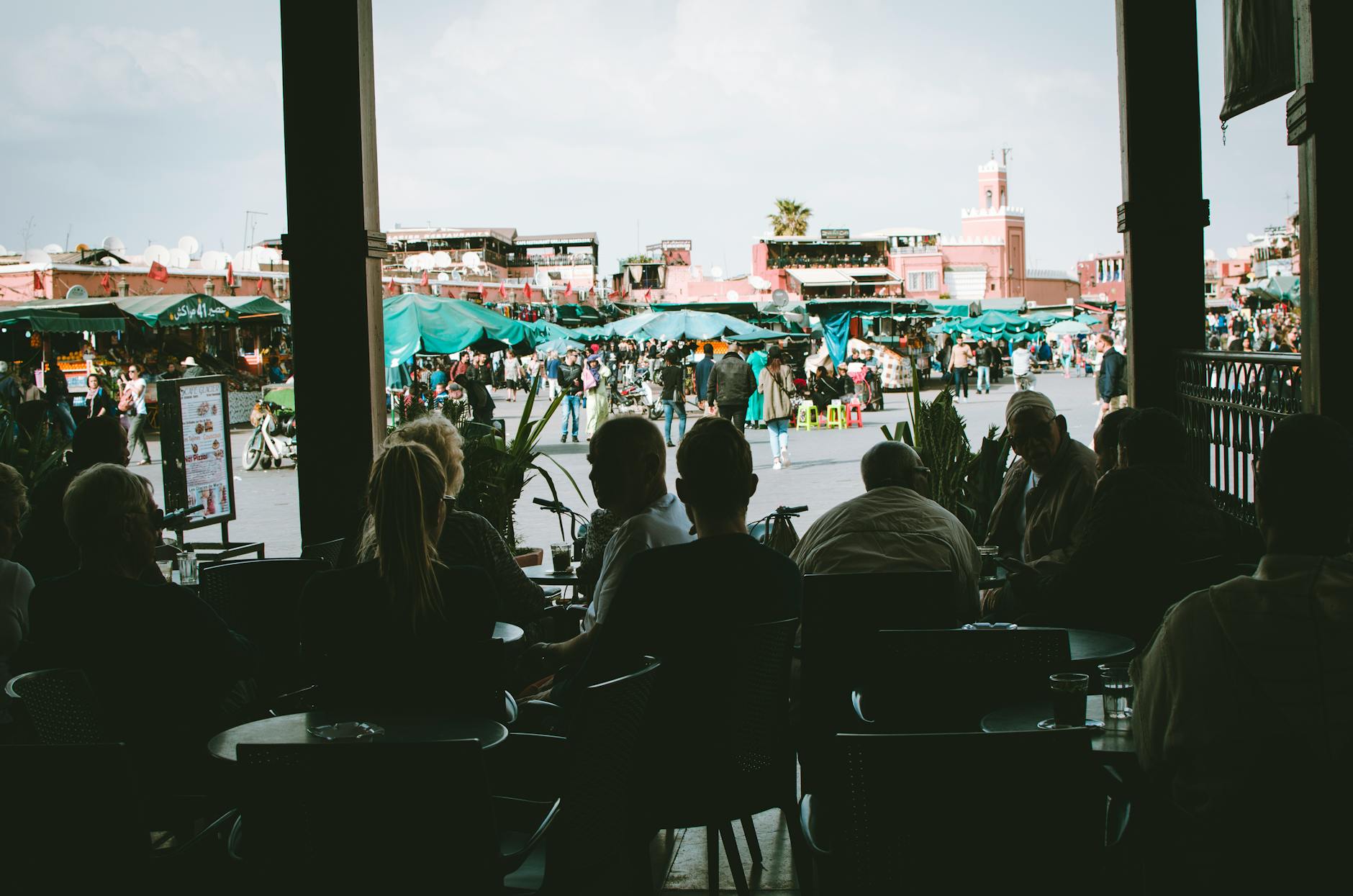 View of a busy Moroccan market from a shaded cafe