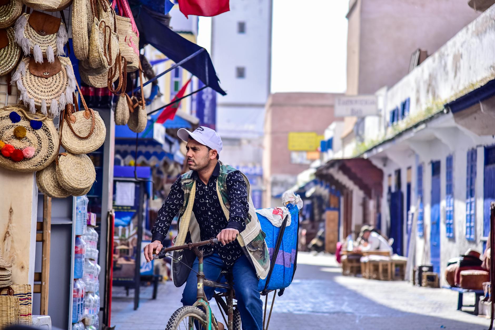 A bicycle moving through a market street in Essaouira, Morocco