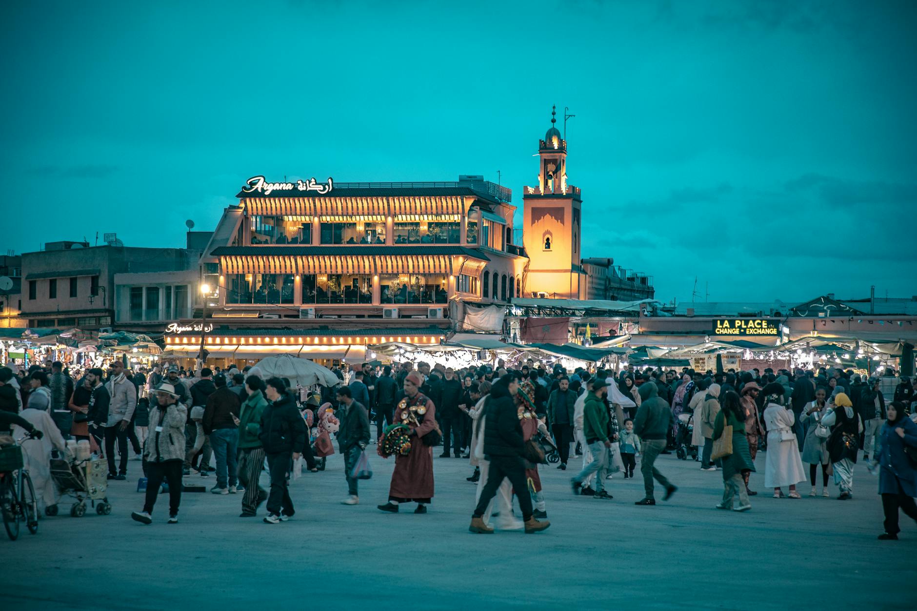 Crowd gathered at Jemaa el-Fnaa square in Marrakesh at dusk