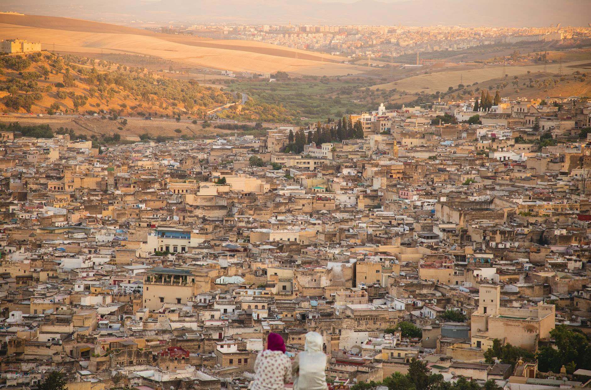 Visitors overlooking an old Moroccan town from above