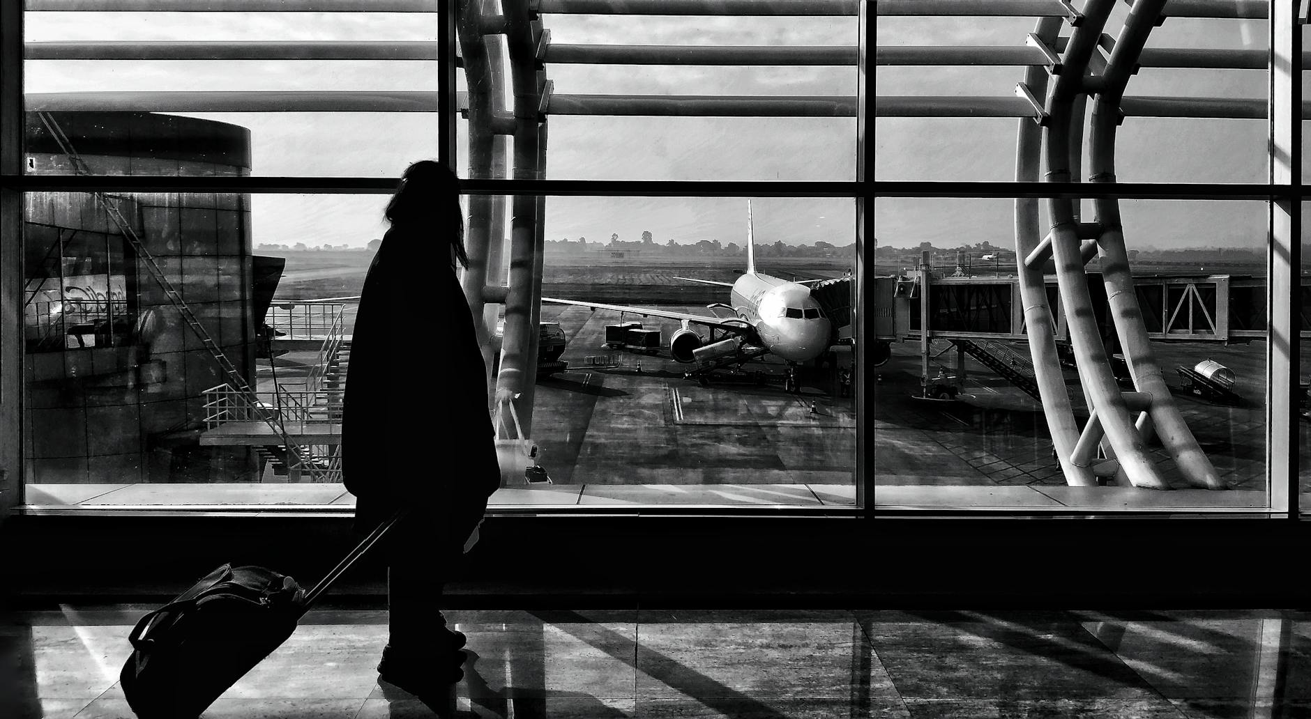 Traveler silhouette walking through an airport terminal