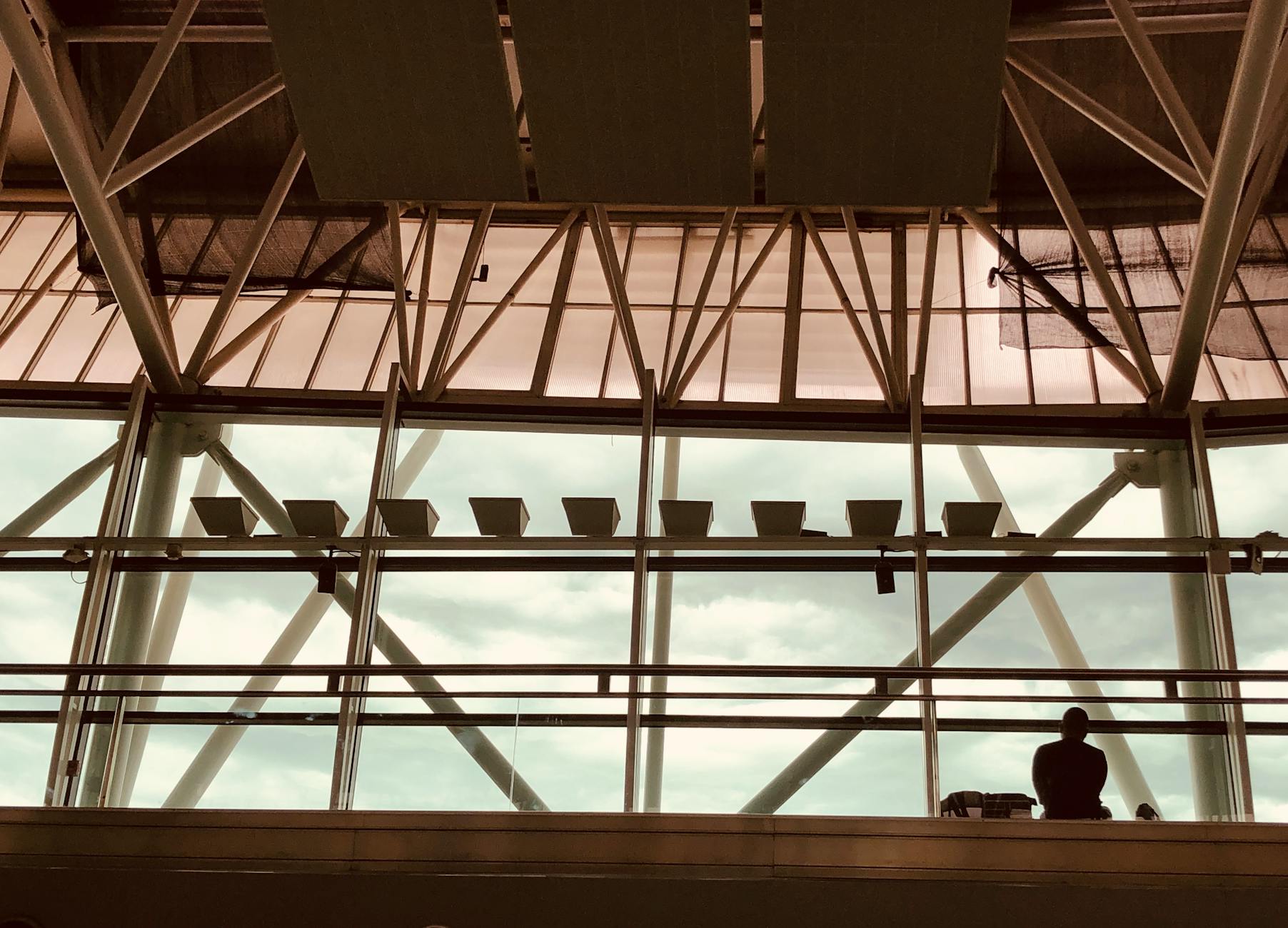 Traveler seated inside a modern airport terminal