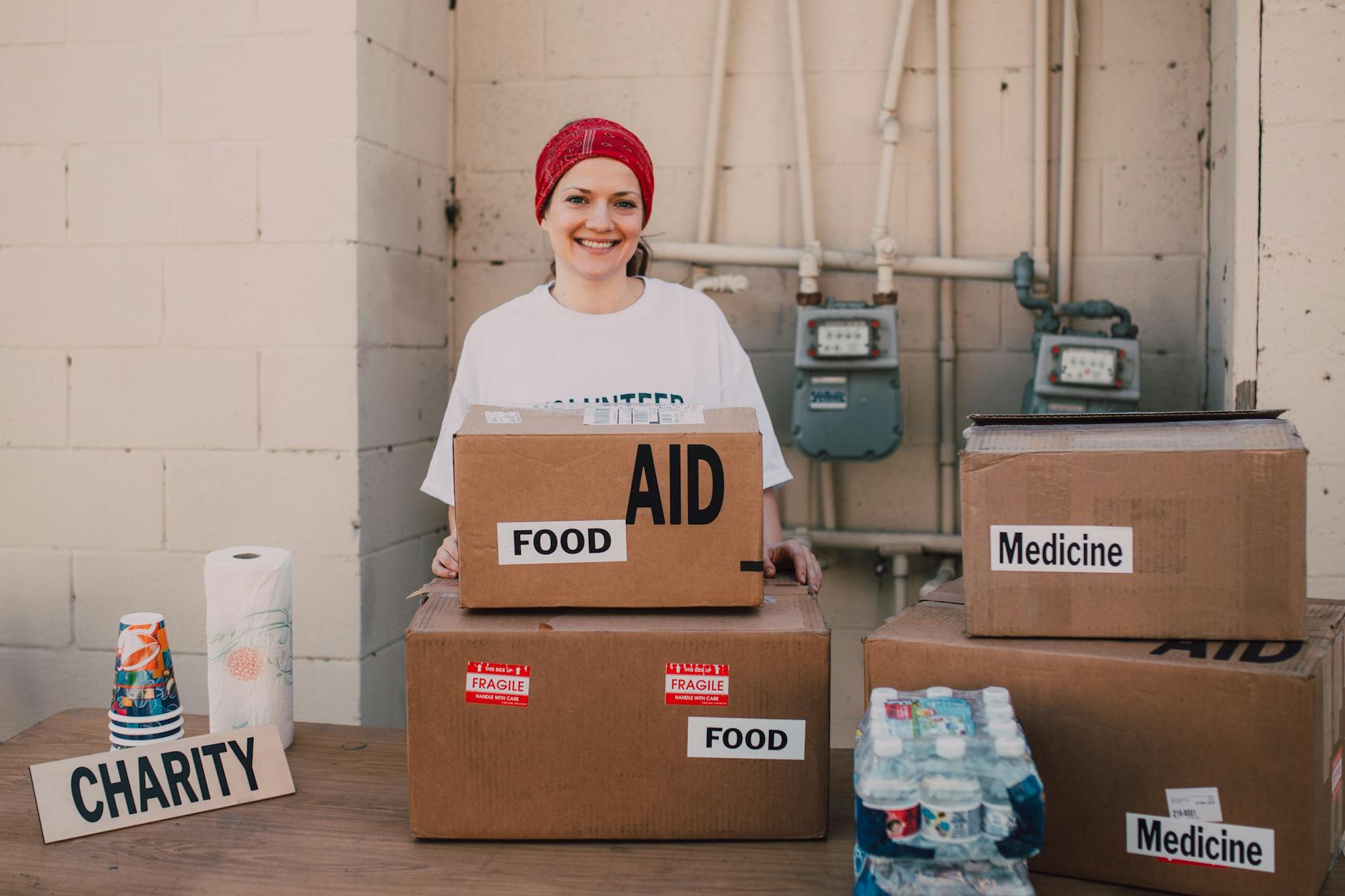 Volunteer distributing aid packages outdoors