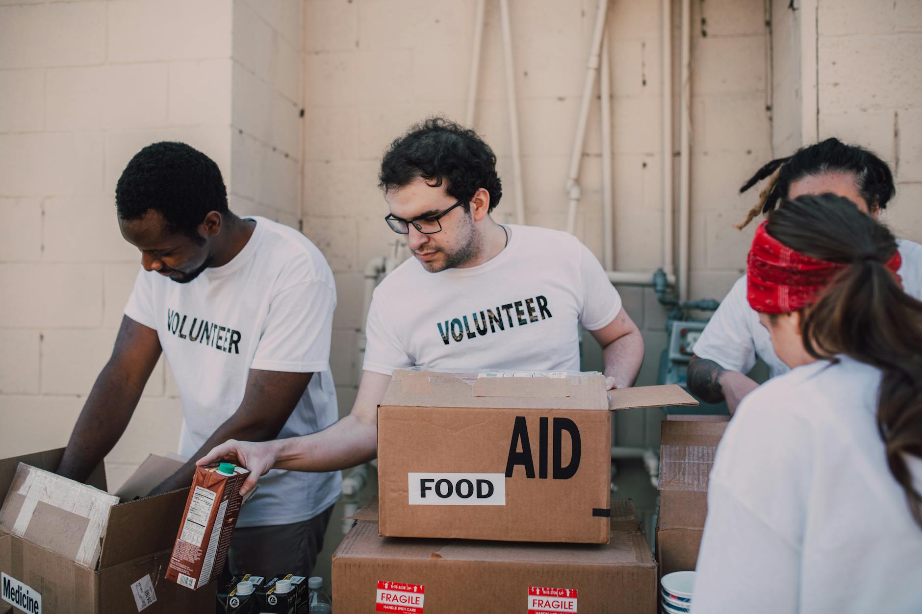 Volunteers packing food and aid boxes during a charity drive