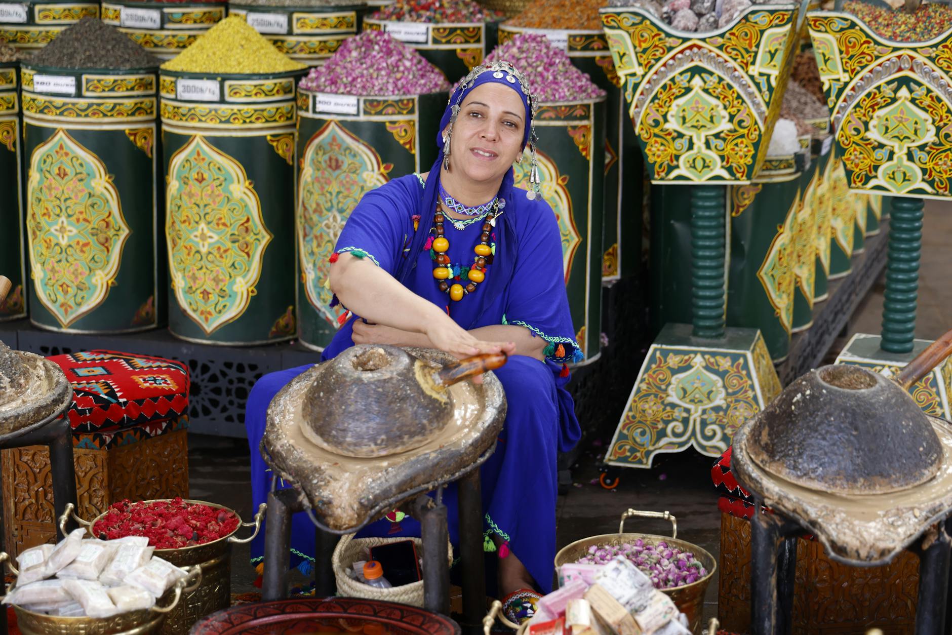 Moroccan woman selling spices in a traditional bazaar