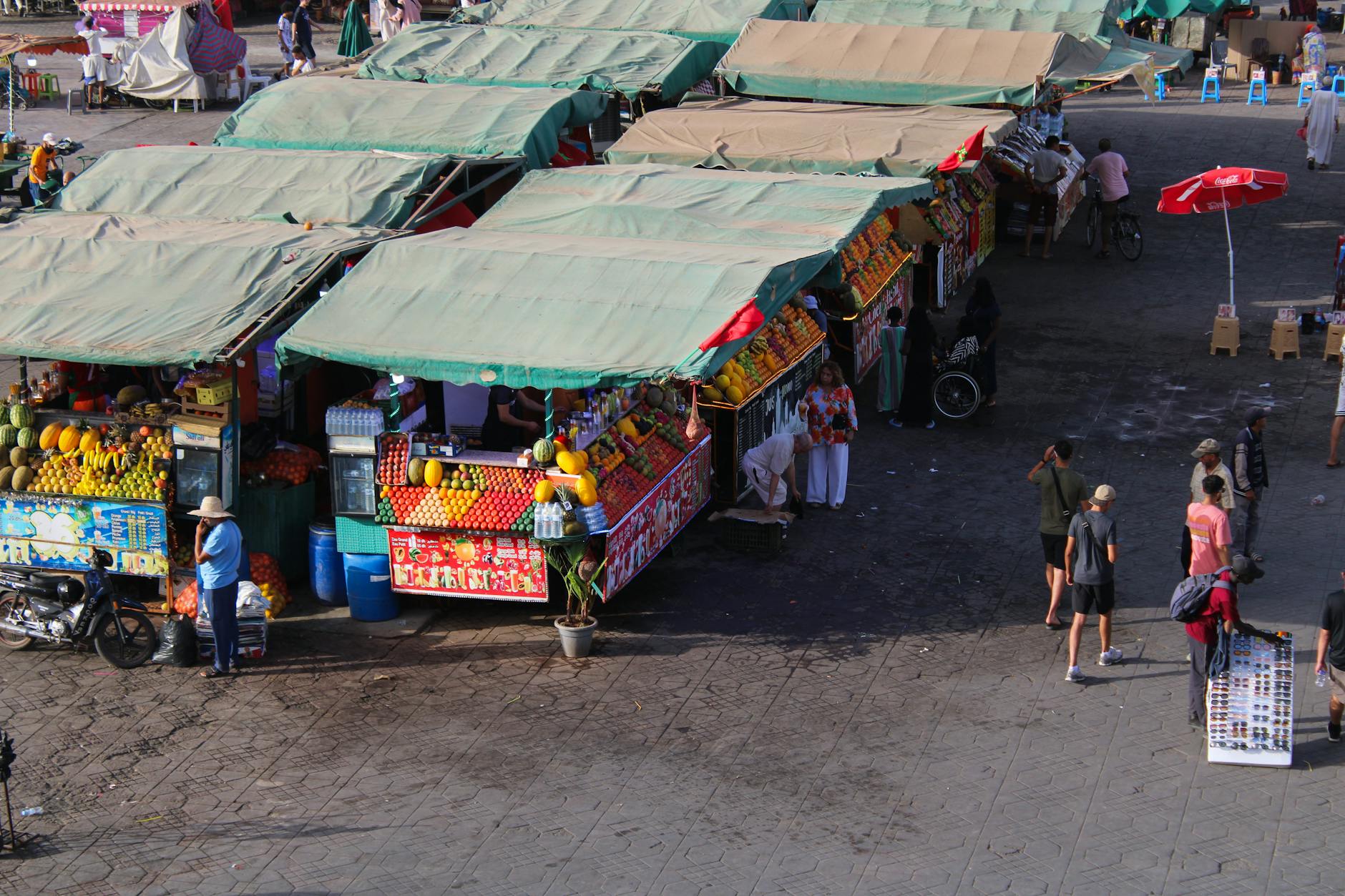 Colorful Moroccan souk stalls in Marrakech with vendors and produce