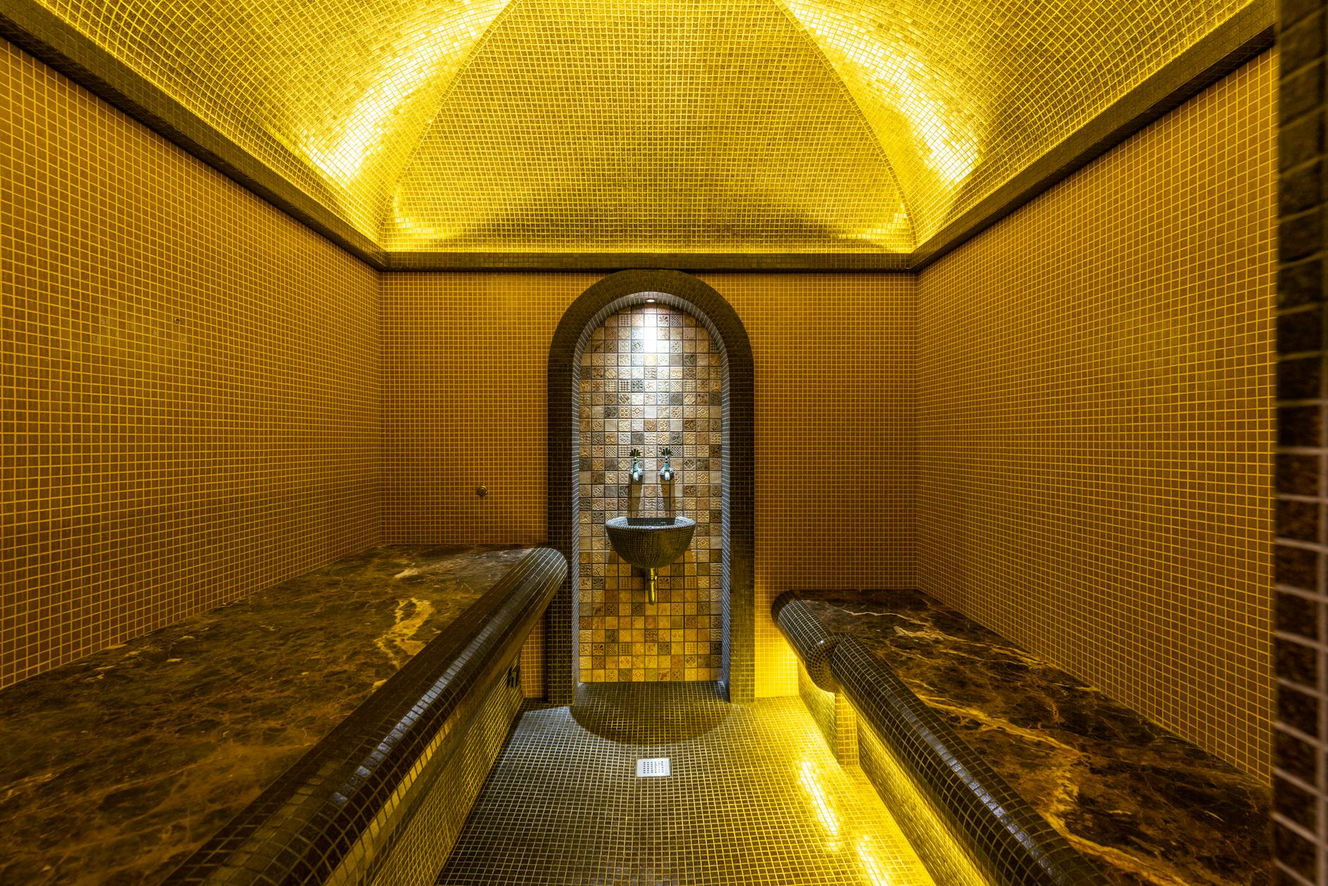 Elegant mosaic bathhouse interior with warm lighting