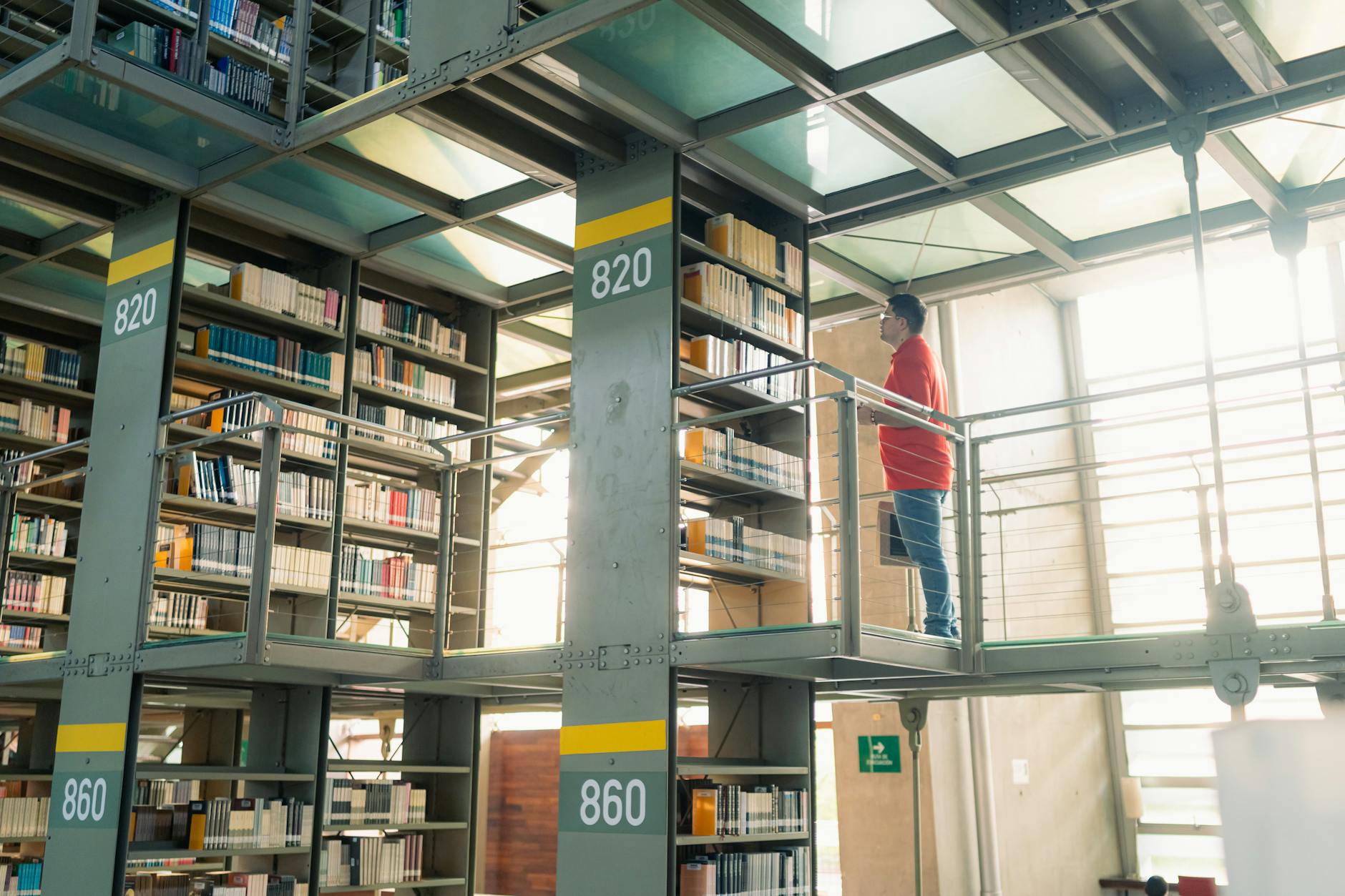 Student browsing bookshelves in a modern Mexico City library