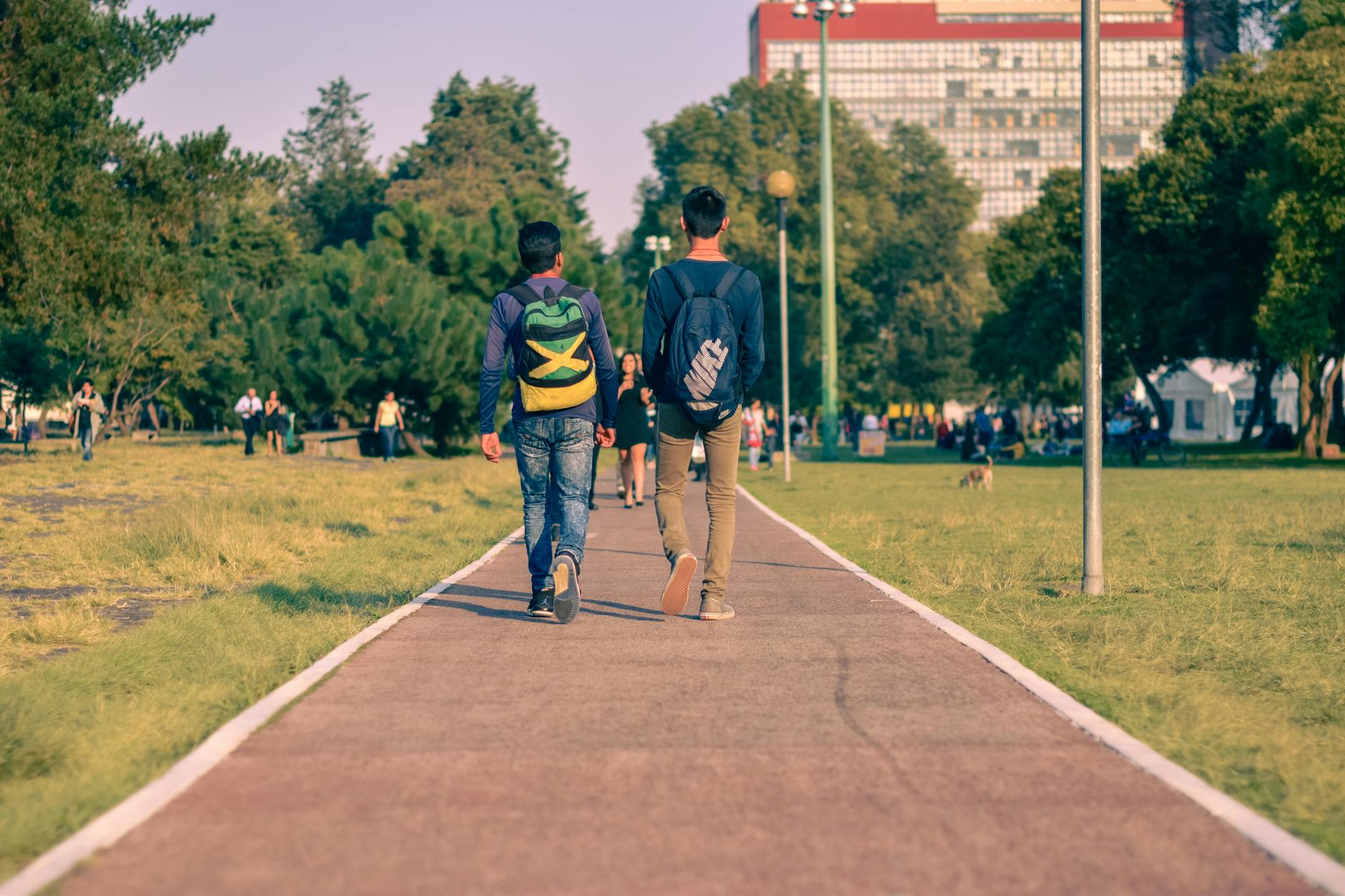People walking on a green park path in Mexico City