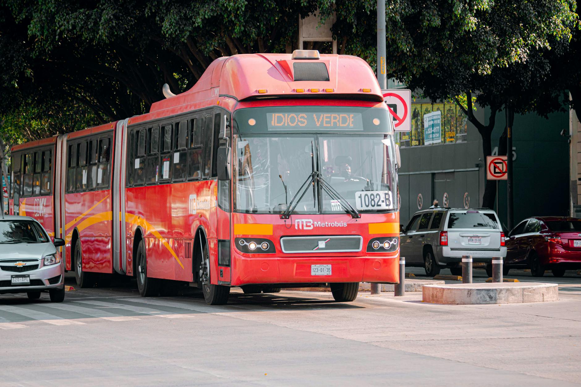 Red Metrobus moving through a Mexico City street