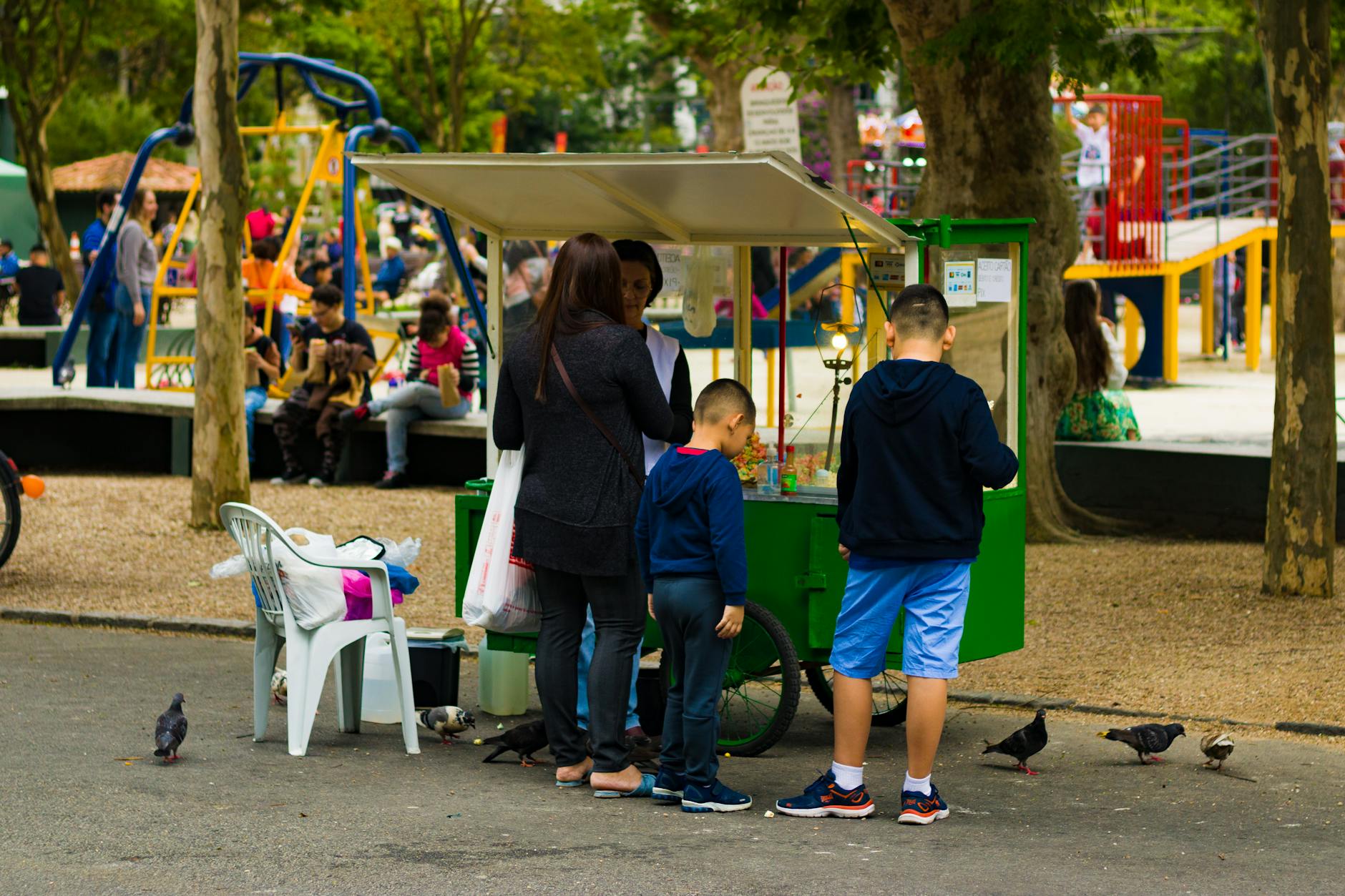 Family standing by a food stand in a park