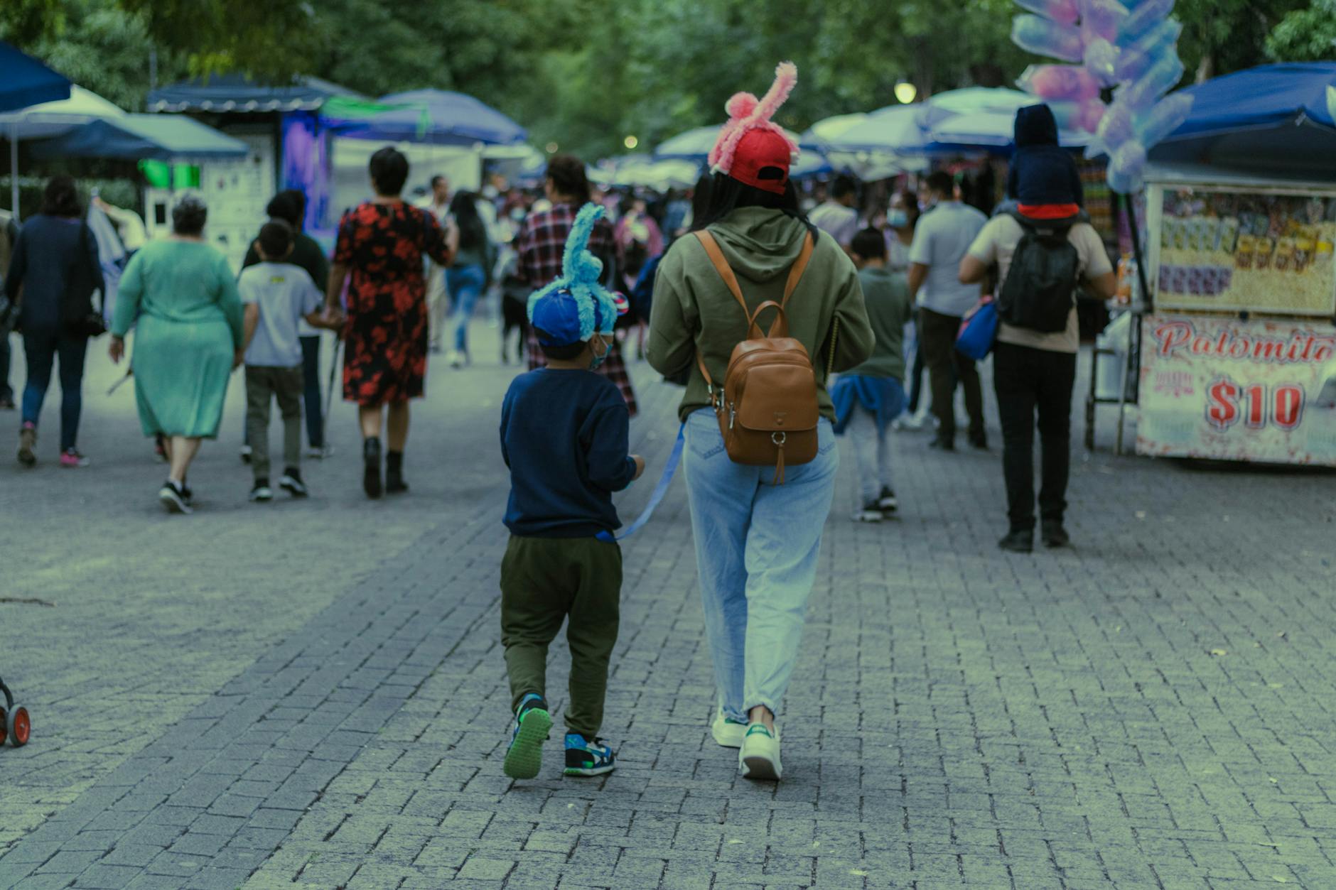 Busy Mexico City market street with pedestrians and vendor stalls