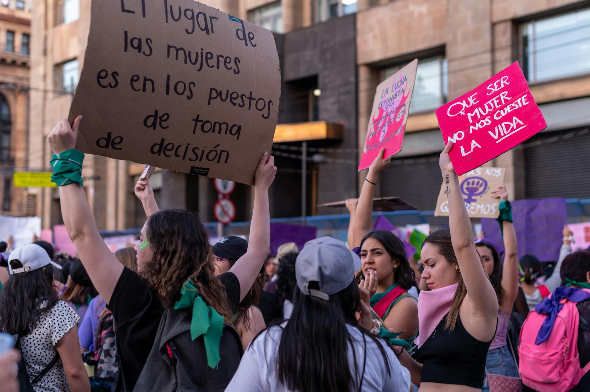 Women holding signs at a protest in Mexico City