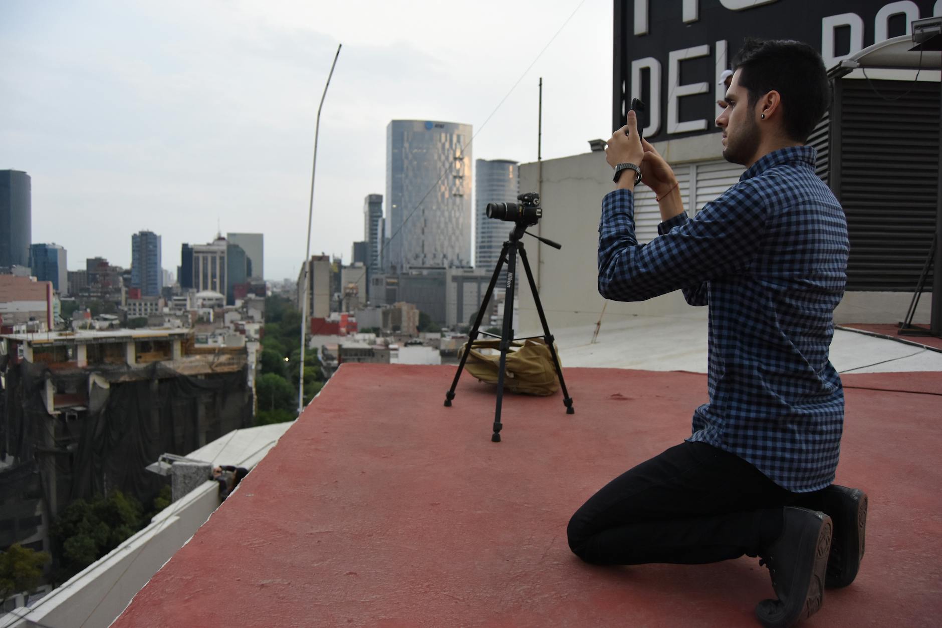 Photographer using a tripod on a Mexico City rooftop