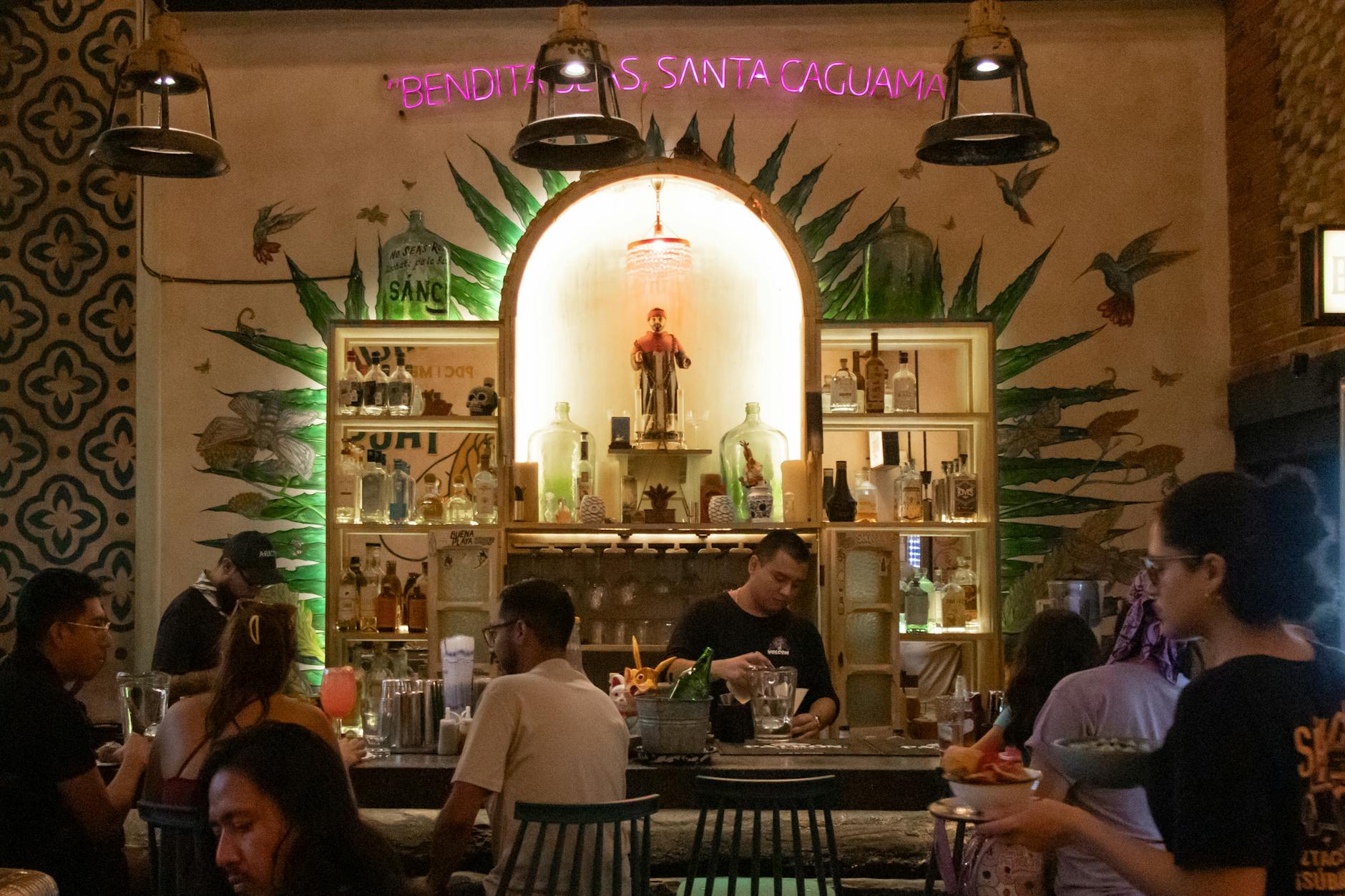 Patrons enjoying drinks in a Mexico City bar