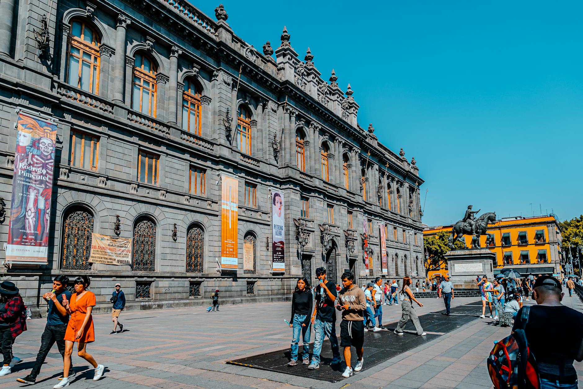 Pedestrians outside the National Art Museum in Mexico City