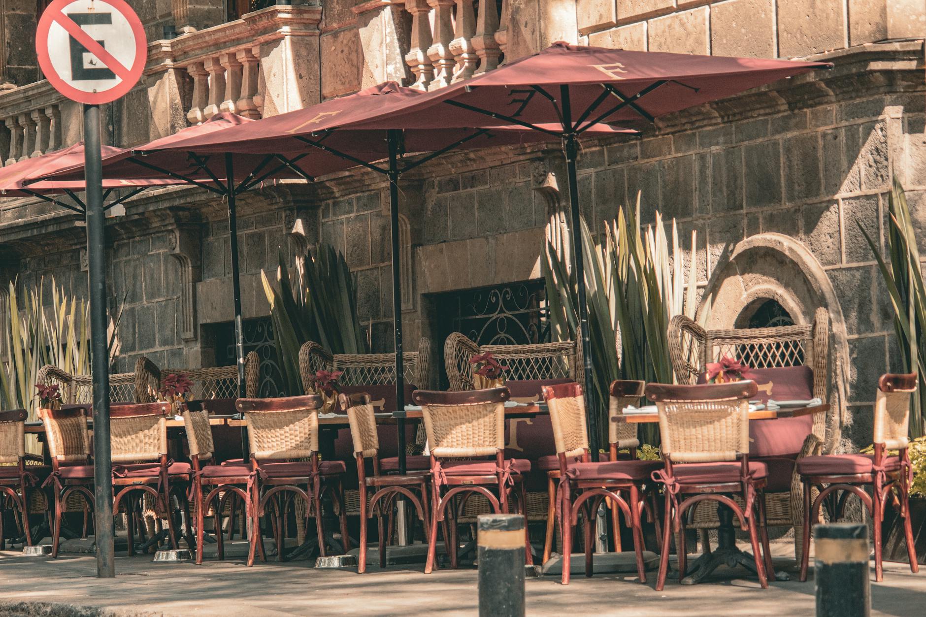 Outdoor cafe seating with red umbrellas in Mexico City