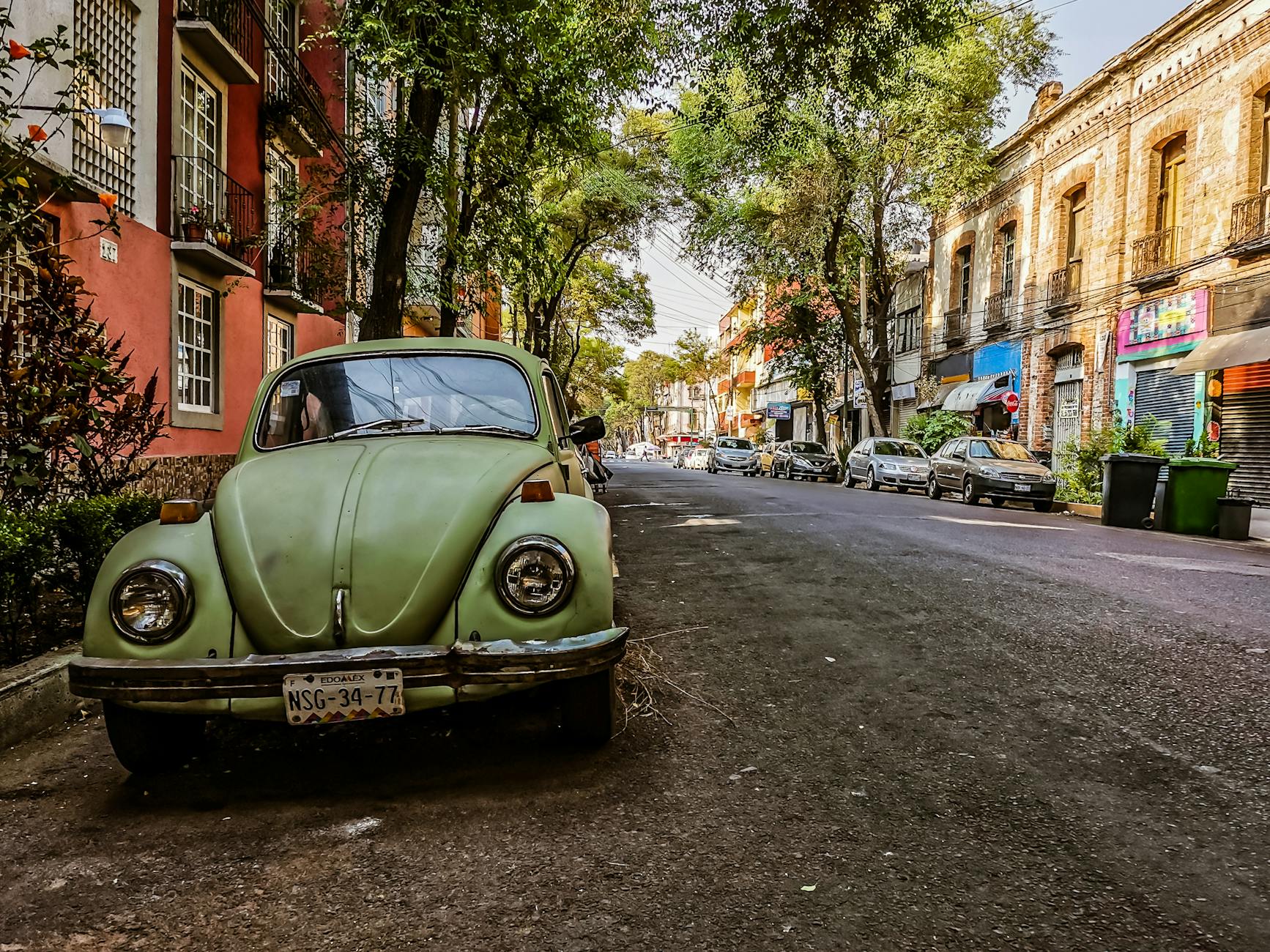 Classic Volkswagen Beetle on a colorful Mexico City street