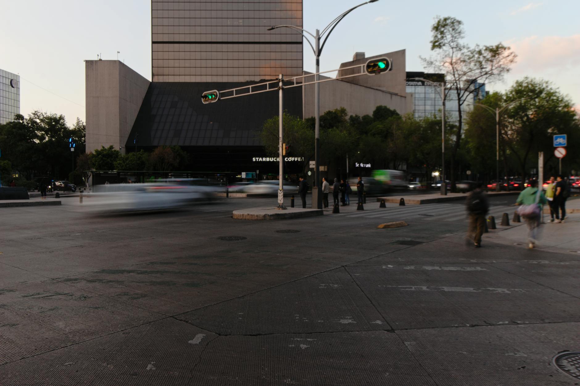 Busy Mexico City intersection with blurred traffic at dusk