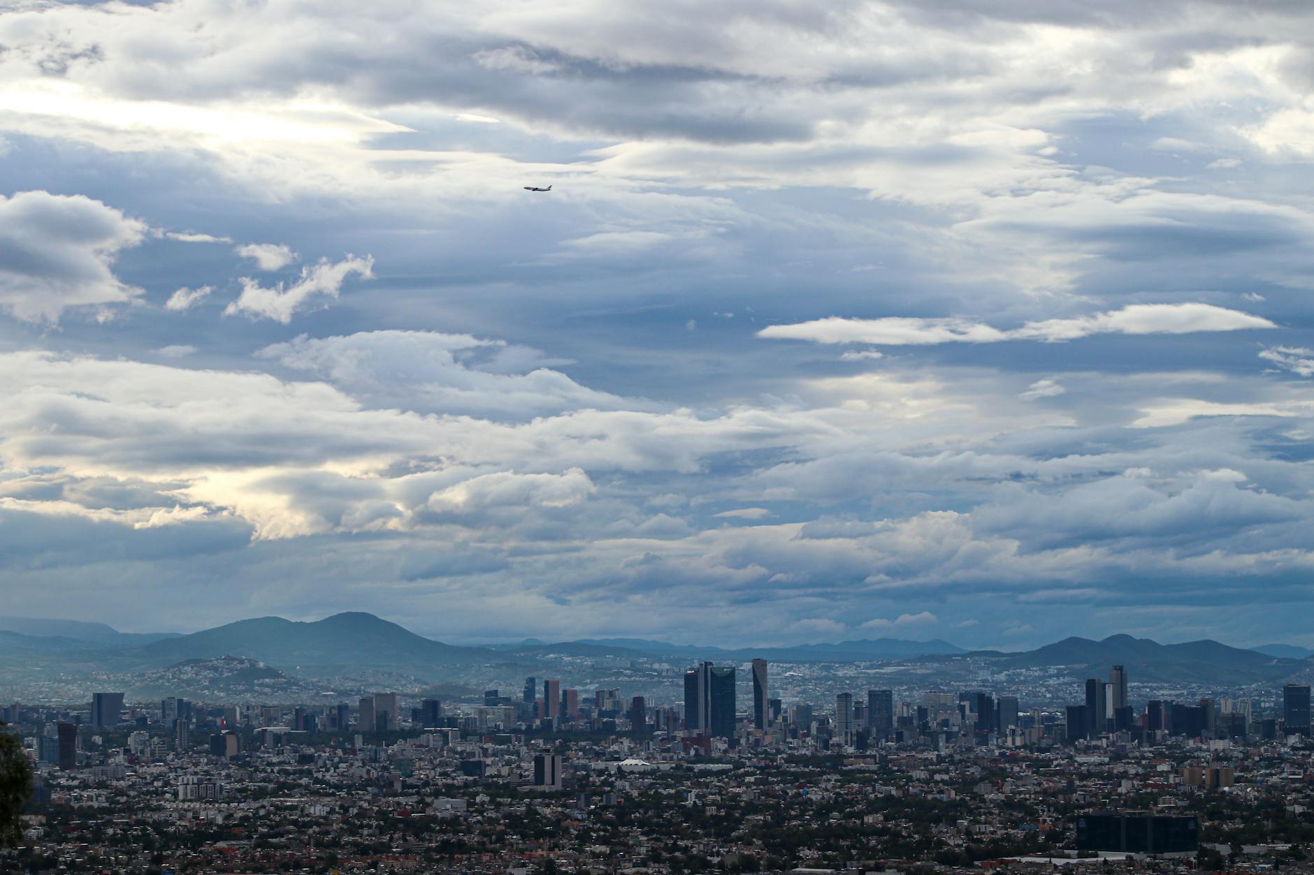 Panoramic aerial view of Mexico City under dramatic clouds
