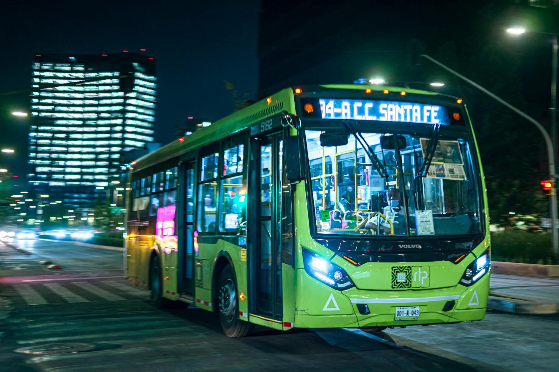 Public bus driving through Mexico City at night