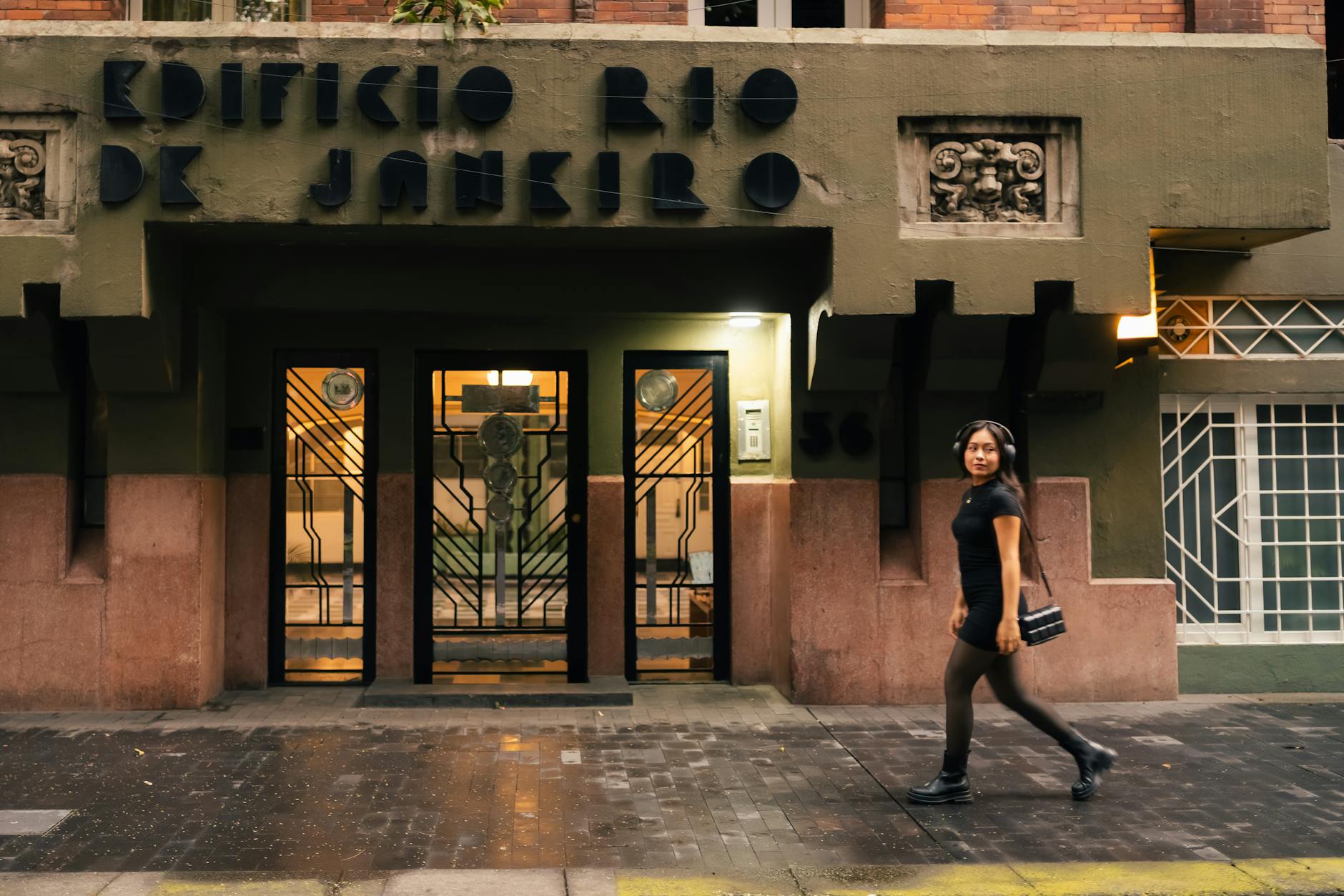 Woman walking by Edificio Rio de Janeiro in Mexico City