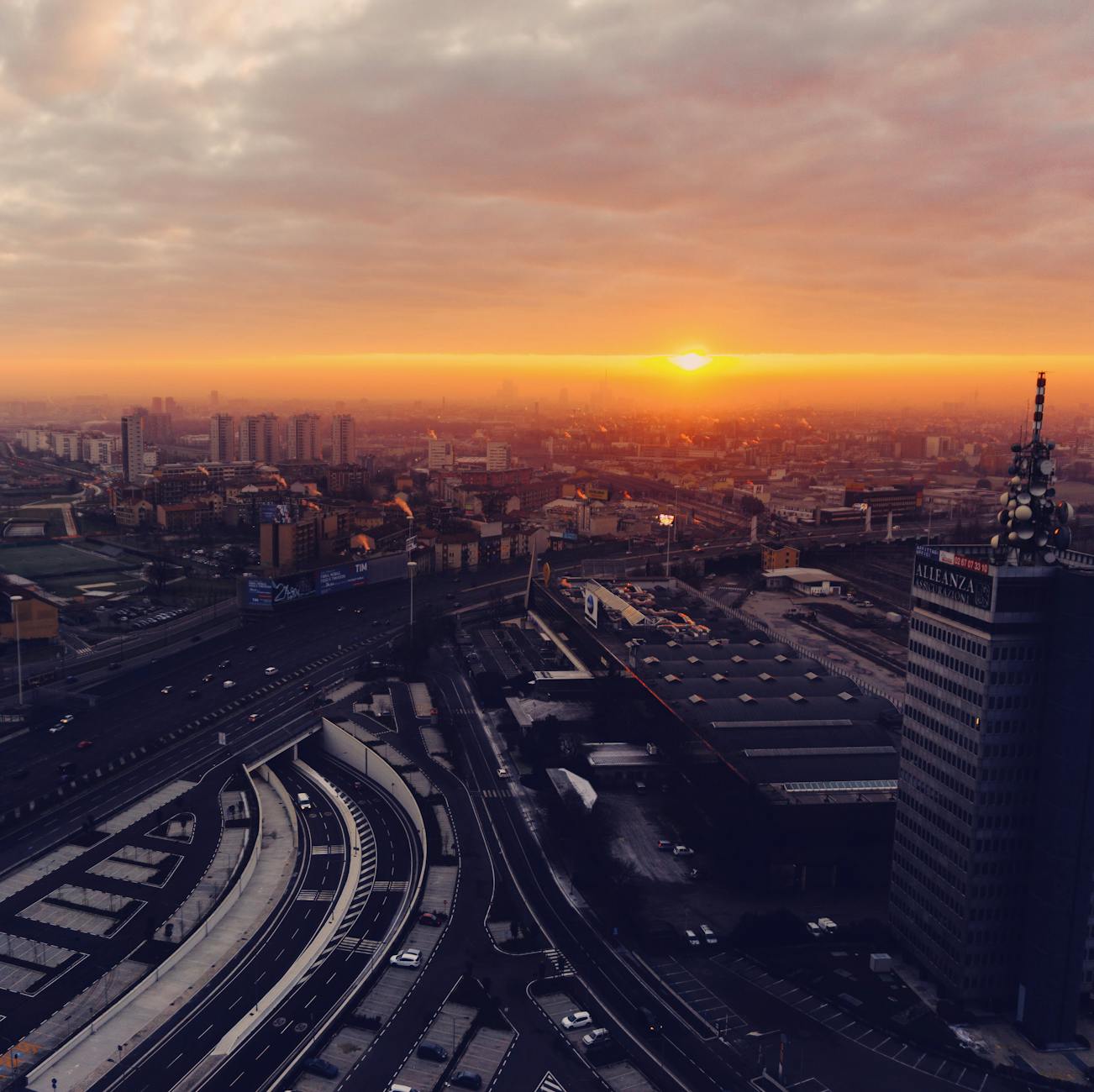 Aerial view of Milan roads and cityscape at sunset