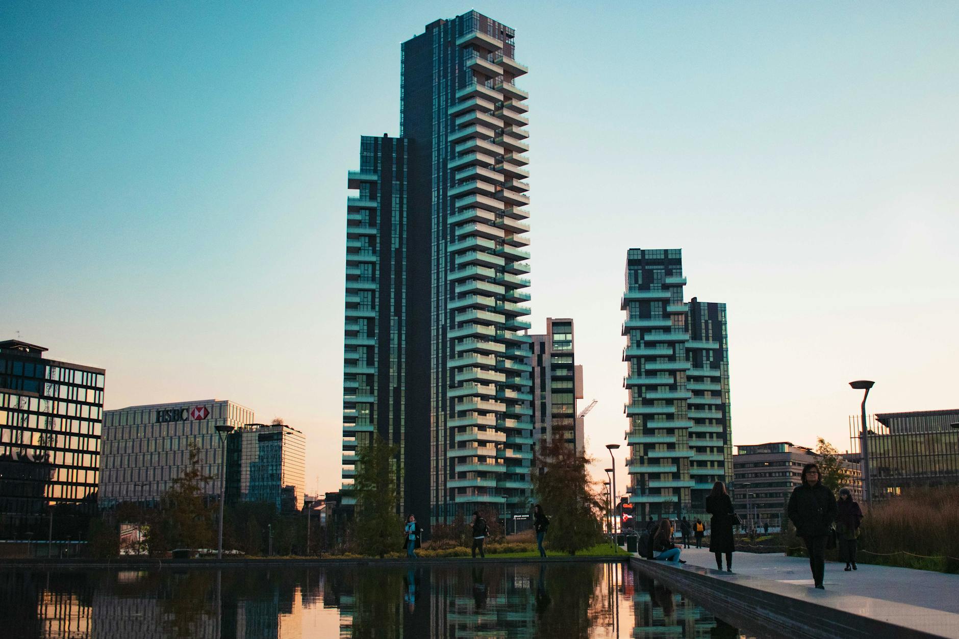 Modern Milan skyscrapers reflected near water