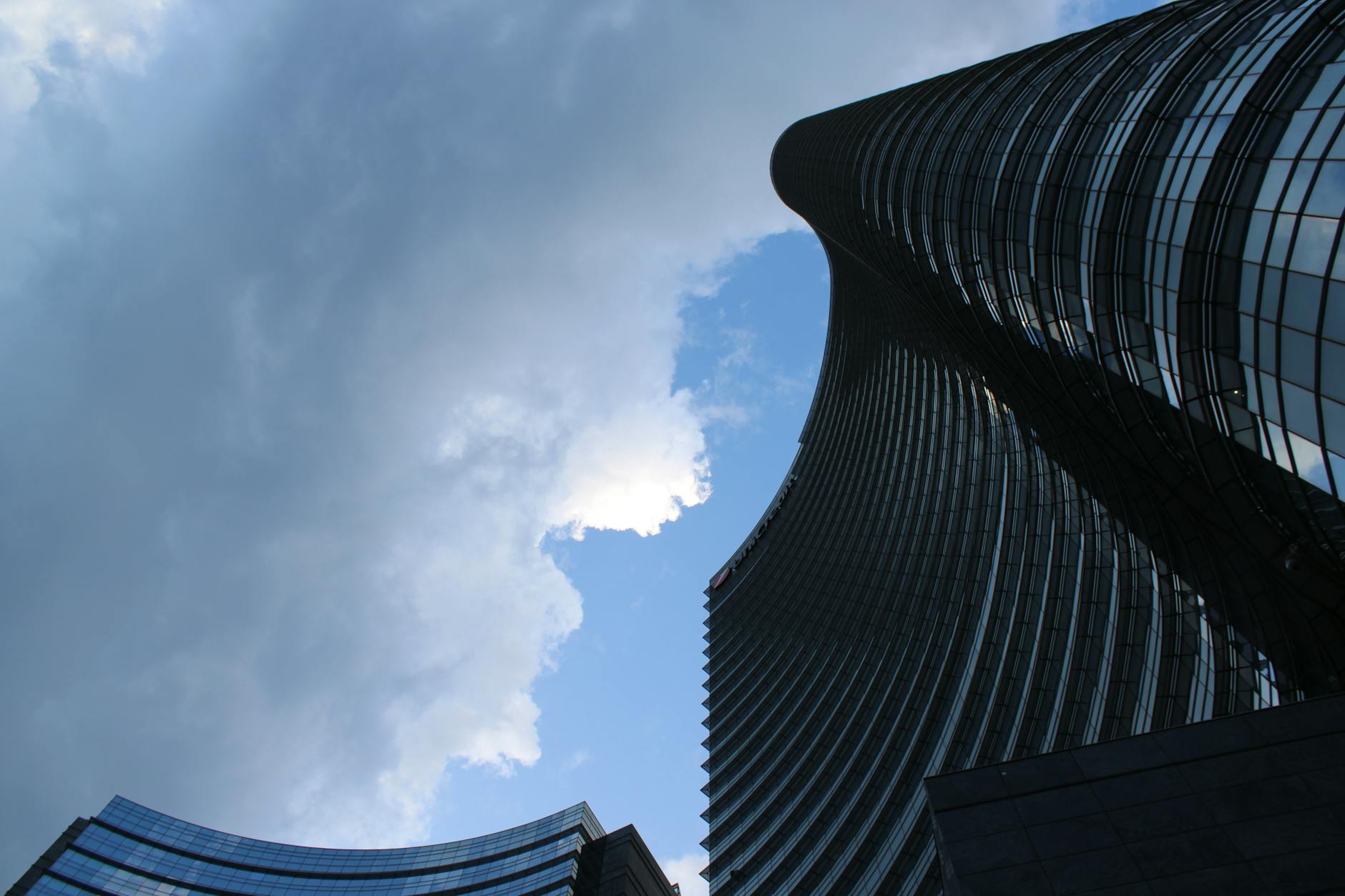 Modern Milan skyscrapers under dramatic sky