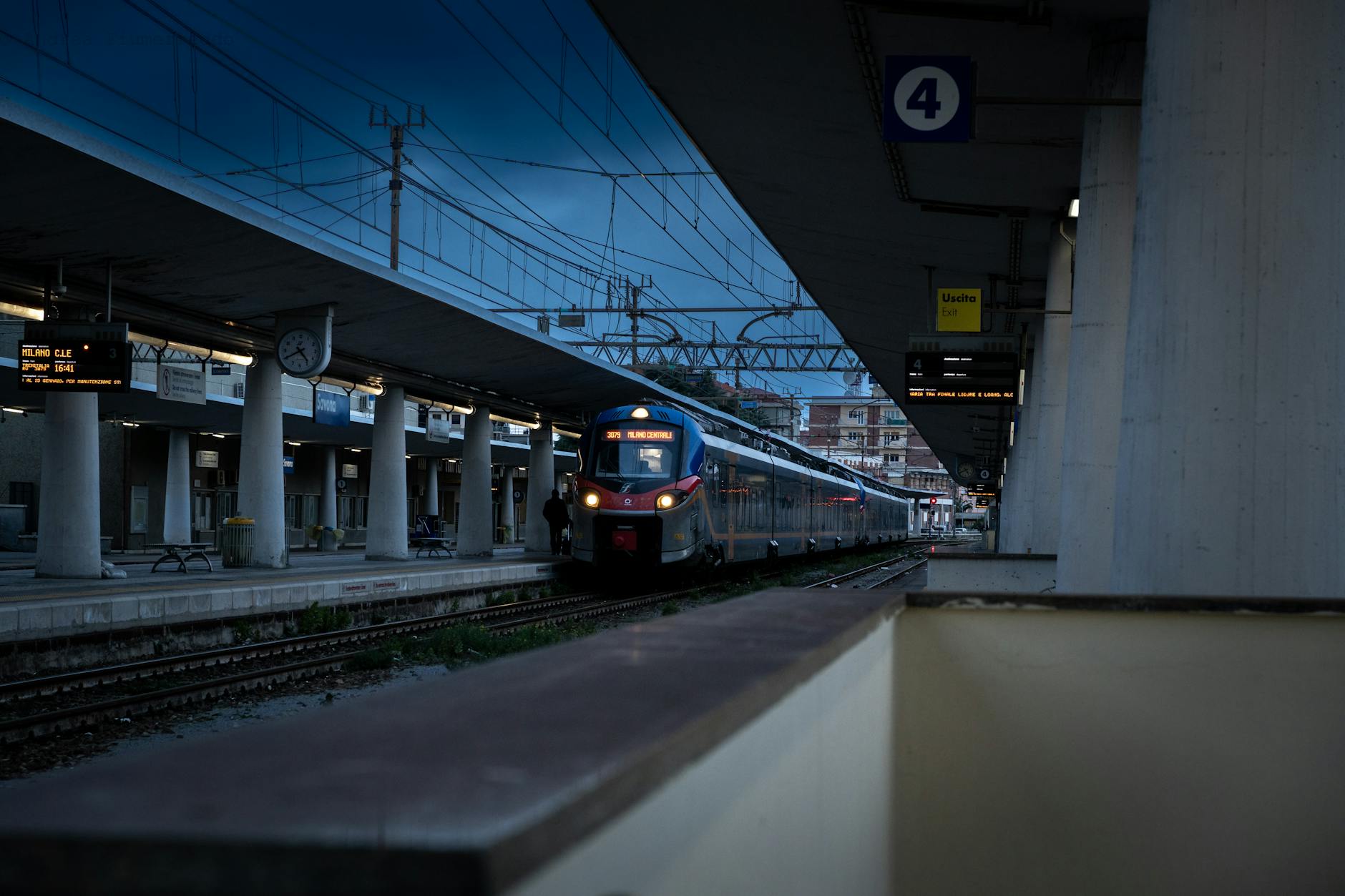 Train arriving at a nighttime station platform