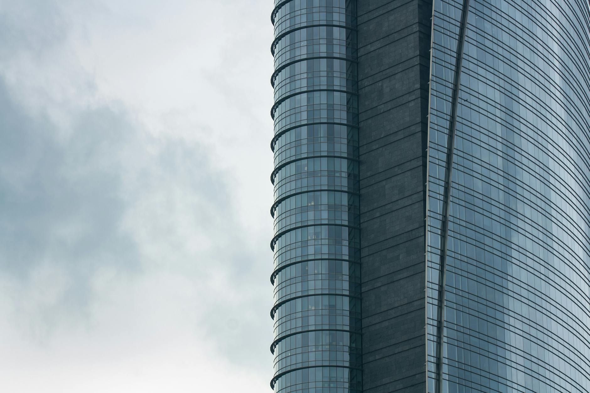 Modern skyscraper in Milan under a cloudy sky