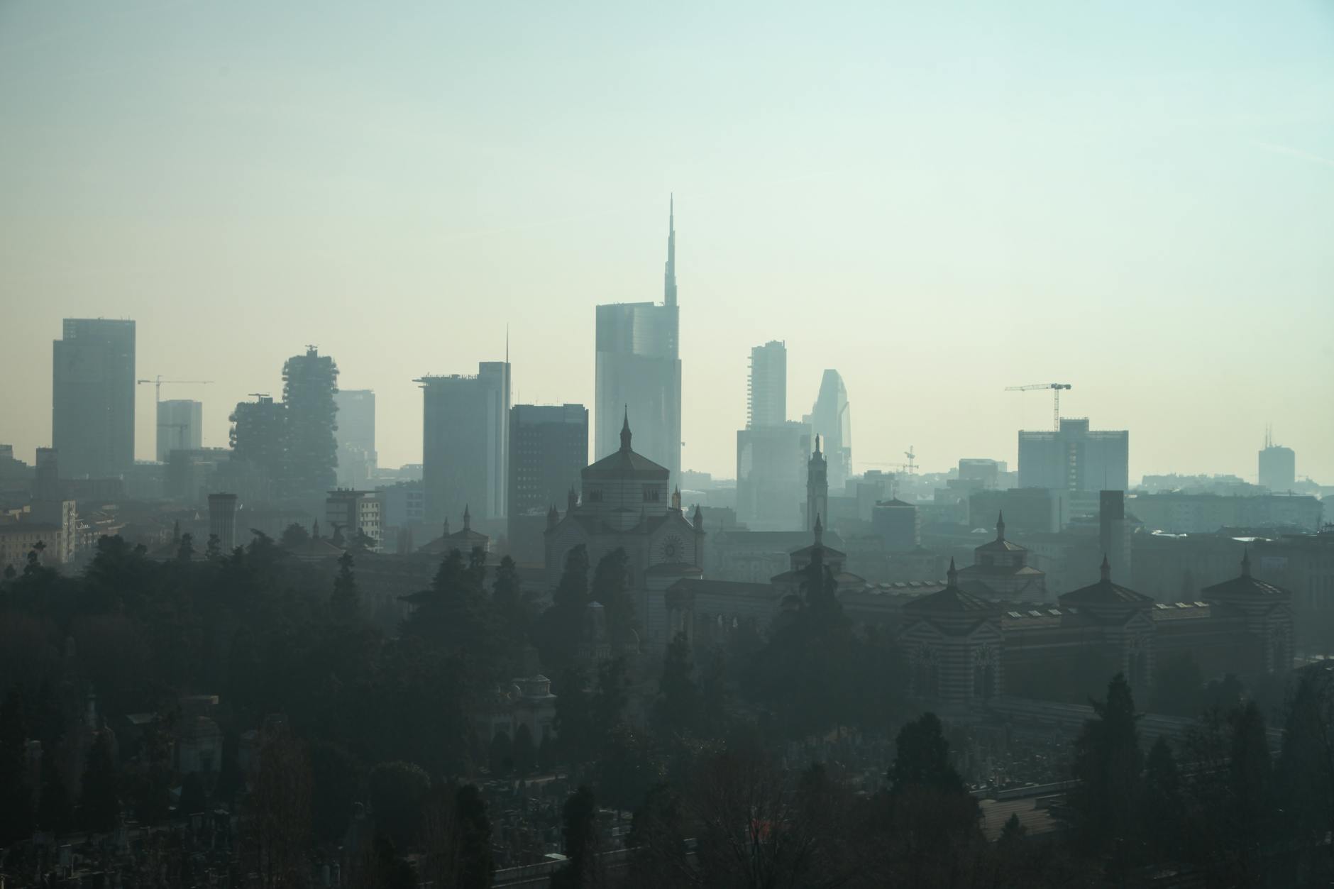 Foggy Milan skyline with modern skyscrapers