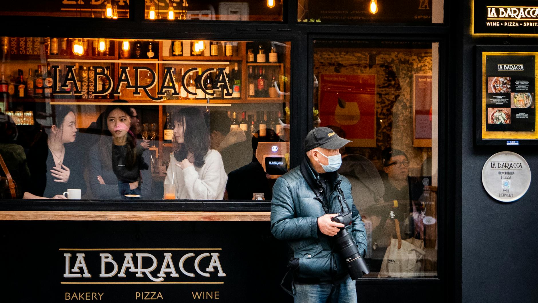 Person holding a camera in an urban setting