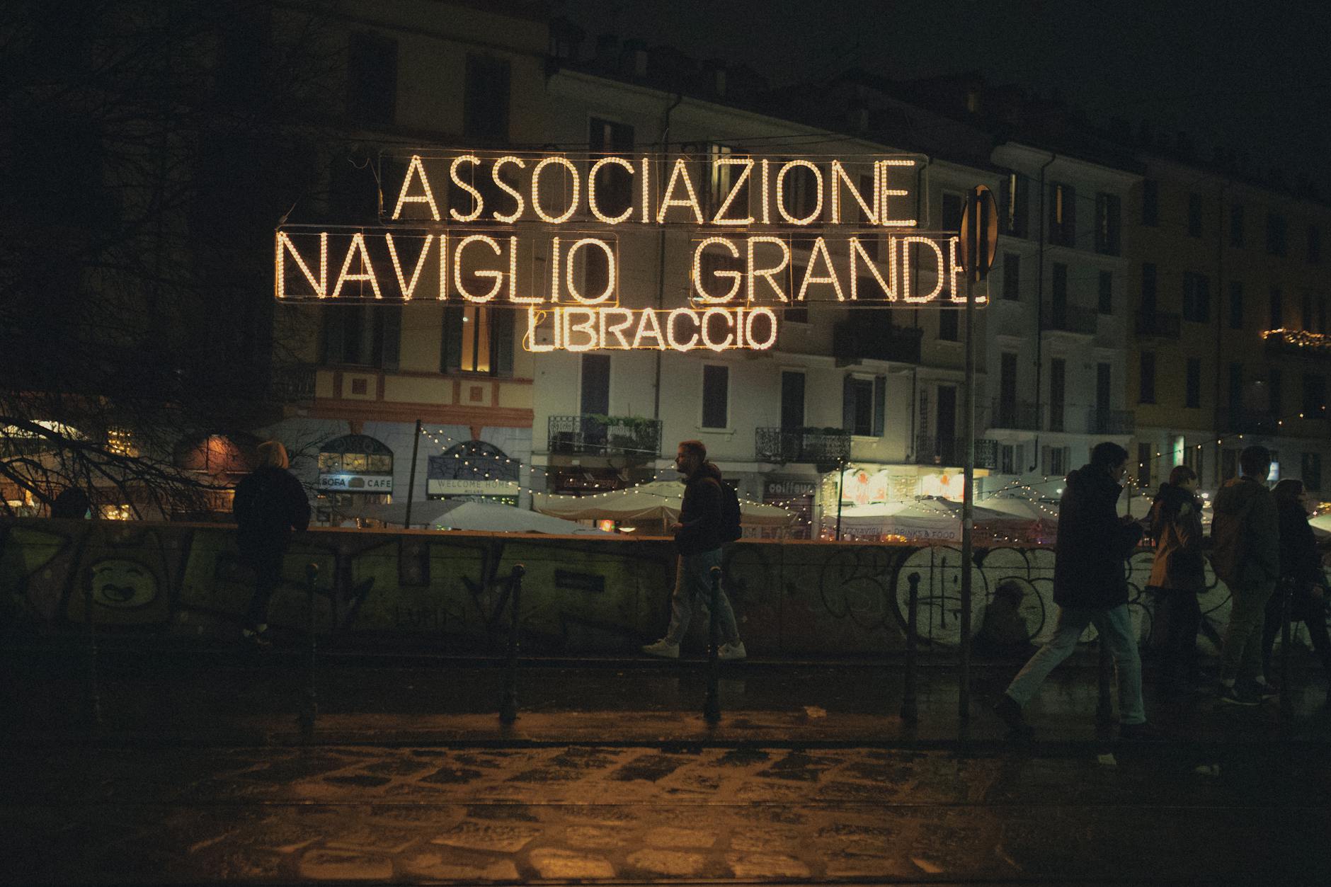 Neon sign on a Milan street at night