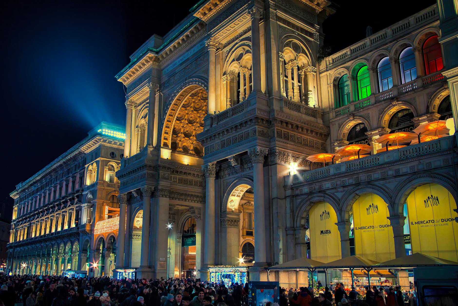 Crowded illuminated Galleria Vittorio Emanuele II in Milan