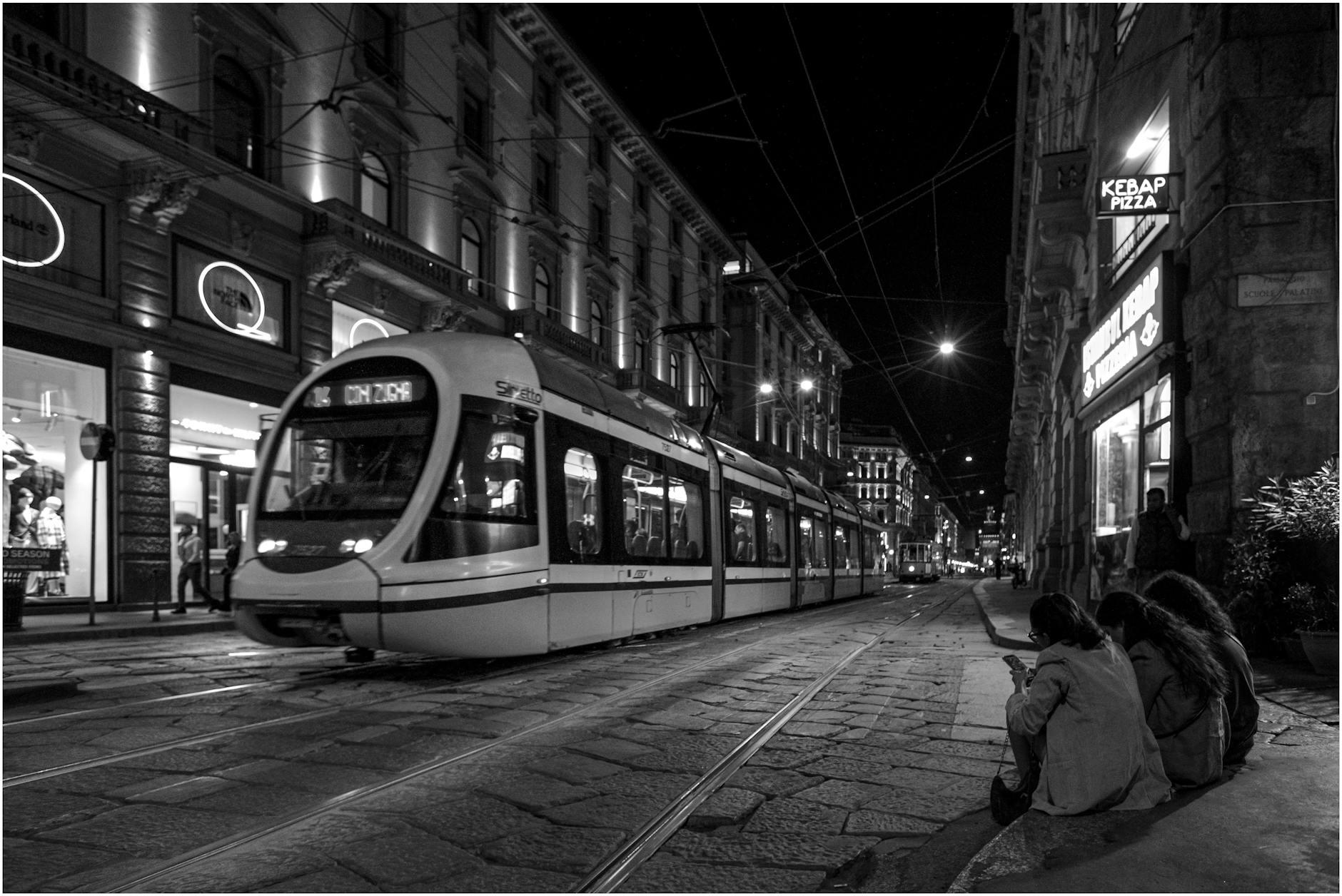 Milan street with tram at night