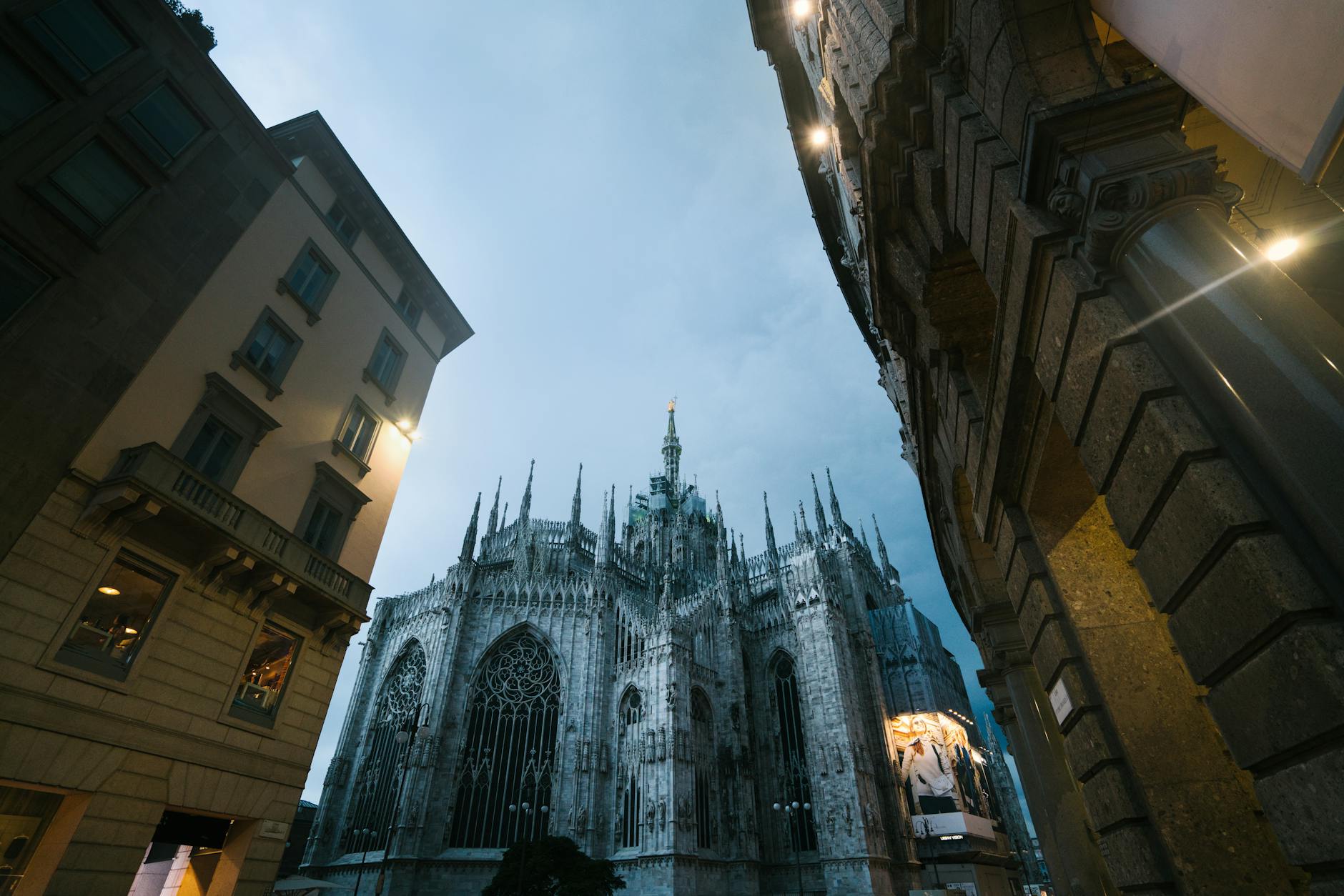 Milan Cathedral and city street in the evening