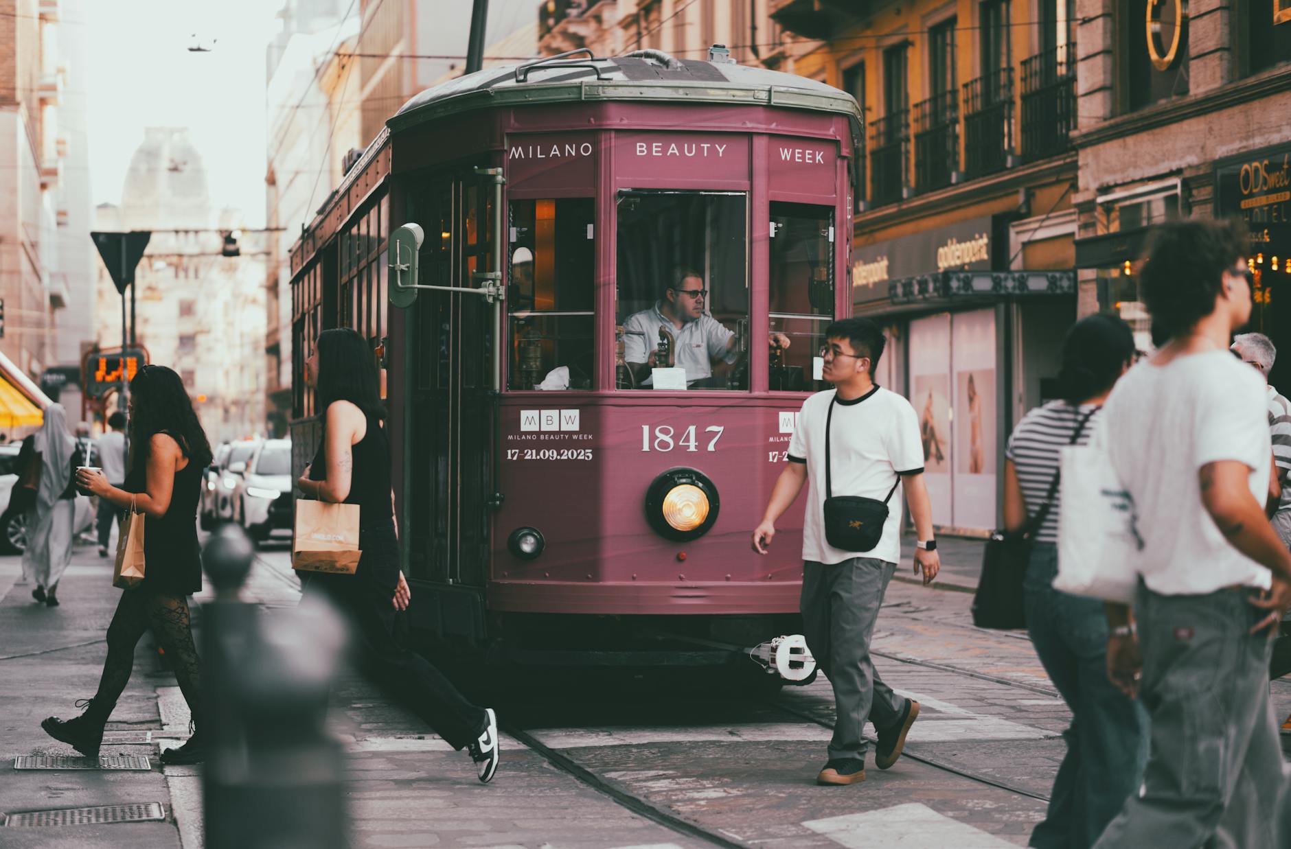 Milan tram surrounded by pedestrians