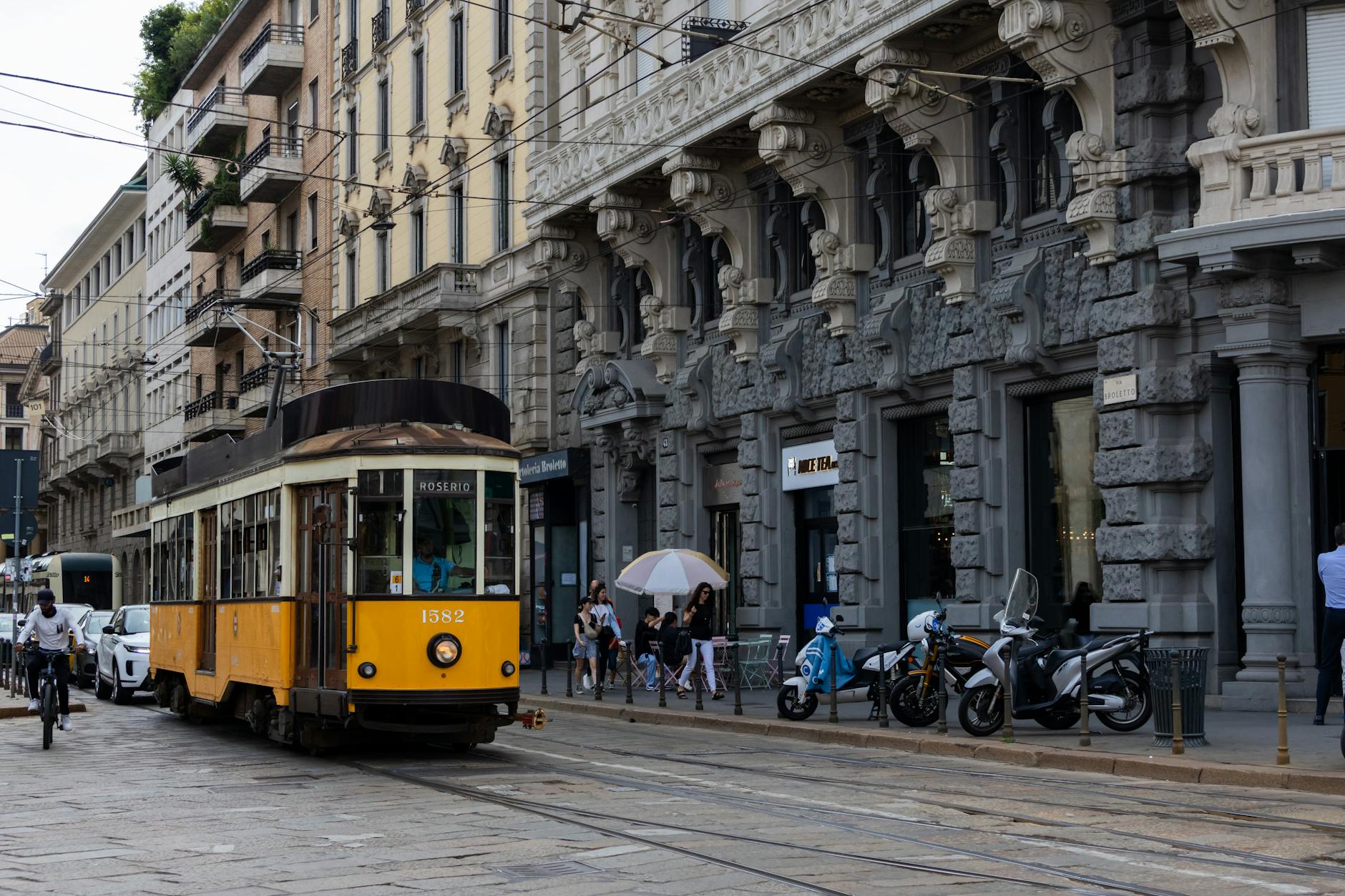 Yellow tram on a historic Milan street
